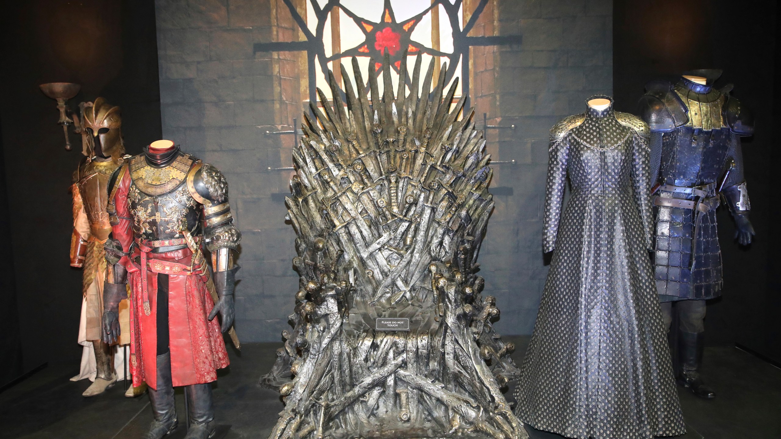 FILE - The Iron Throne and costumes on display during the launch of The Game of Thrones Touring Exhibition at the Titanic Exhibition centre in Belfast, Northern Ireland, Wednesday, April 10, 2019. (AP Photo, File)