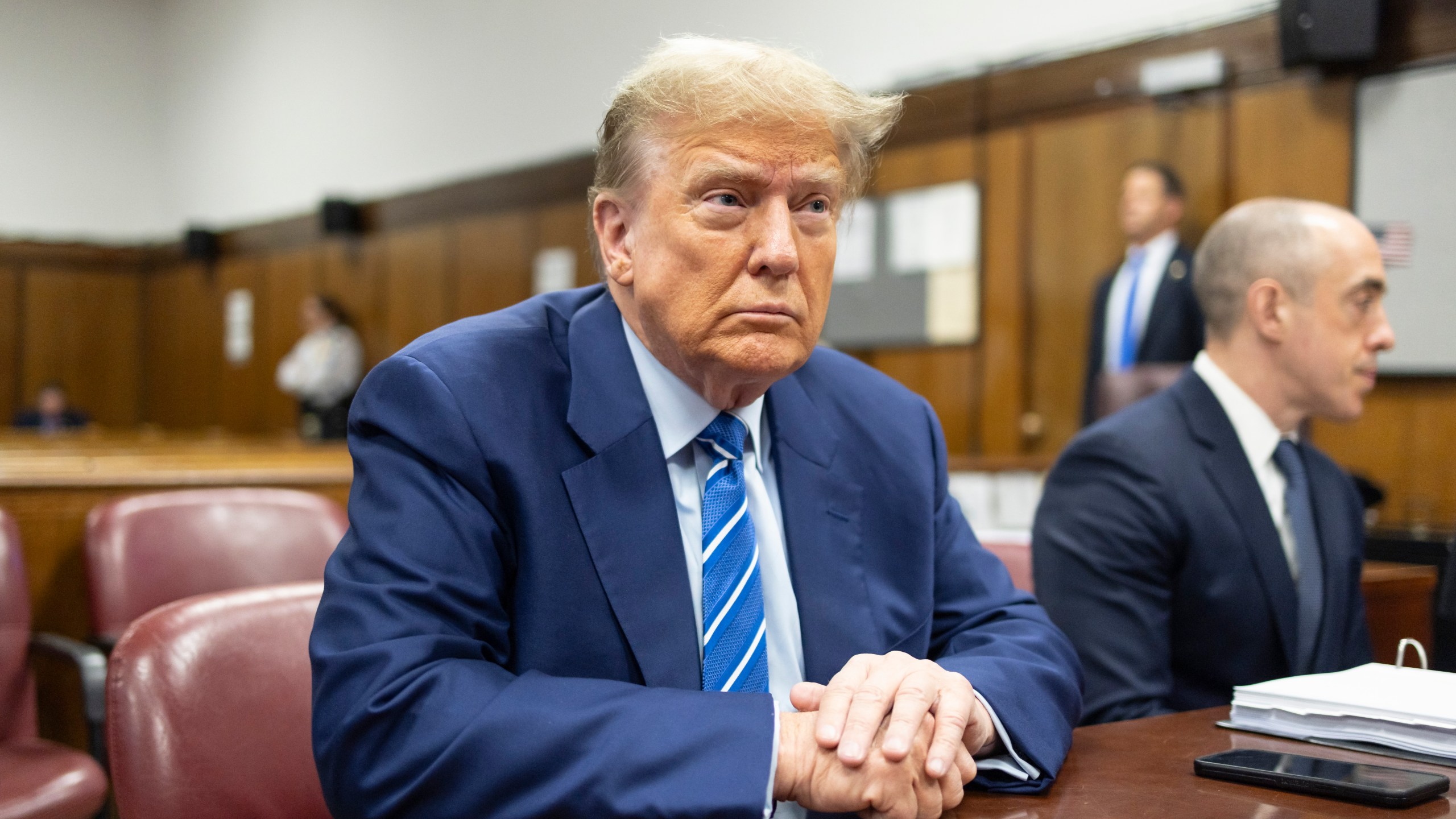 FILE - Former President Donald Trump awaits the start of proceedings on the second day of jury selection at Manhattan criminal court, April 16, 2024, in New York. Manhattan prosecutors are balking at Donald Trump efforts to delay post-trial decisions in his New York hush money criminal case as he seeks to have a federal court intervene and potentially overturn his felony conviction. They lodged their objections in a letter Tuesday to the trial judge but said they could be OK with postponing the ex-president’s Sept. 18 sentencing. (Justin Lane/Pool Photo via AP)