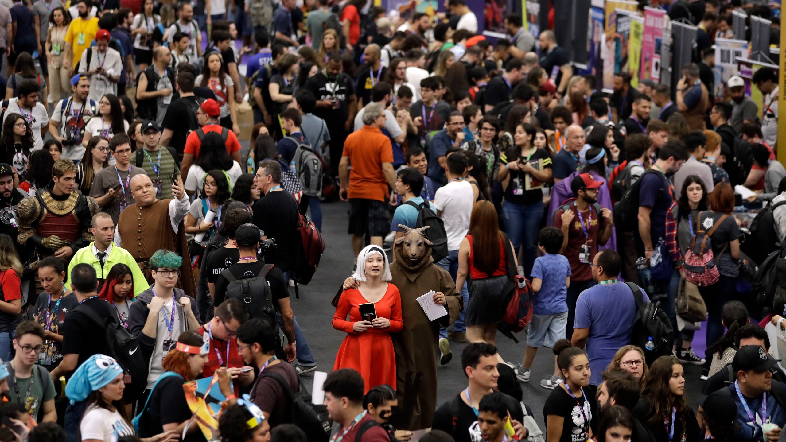 FILE - People attend the Comic Con Experience fair in Sao Paulo, Brazil on Dec. 6, 2018. (AP Photo/Andre Penner, File)