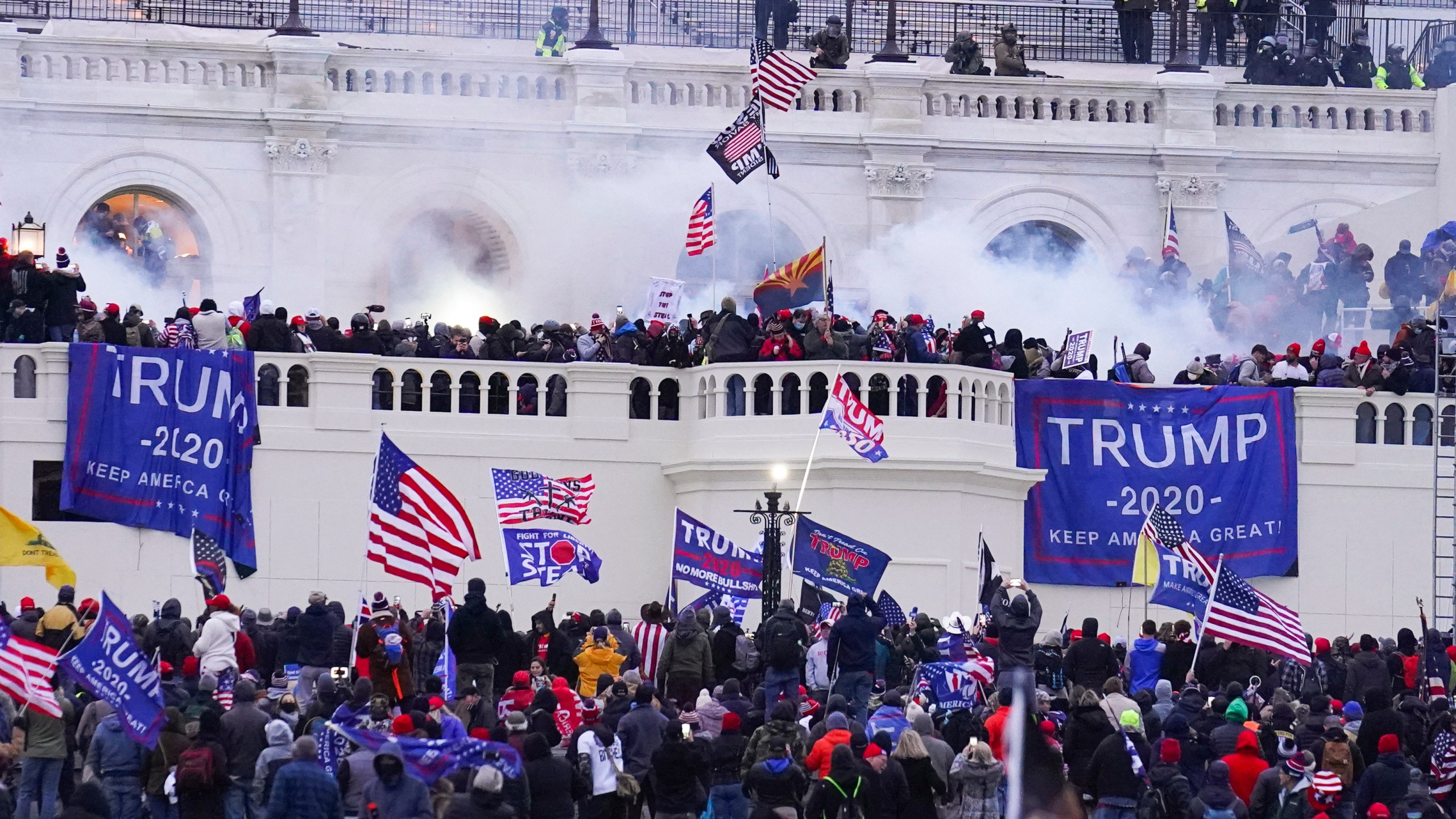 FILE - Rioters at the U.S. Capitol on Jan. 6, 2021, in Washington. A former Virginia police officer who stormed the U.S. Capitol has received a reduced prison sentence of six years. Former Rocky Mount Police Sgt. Thomas Robertson's resentencing on Wednesday makes him one of the first beneficiaries of a recent U.S. Supreme Court ruling that limited the government’s use of a federal obstruction law. (AP Photo/John Minchillo, File)