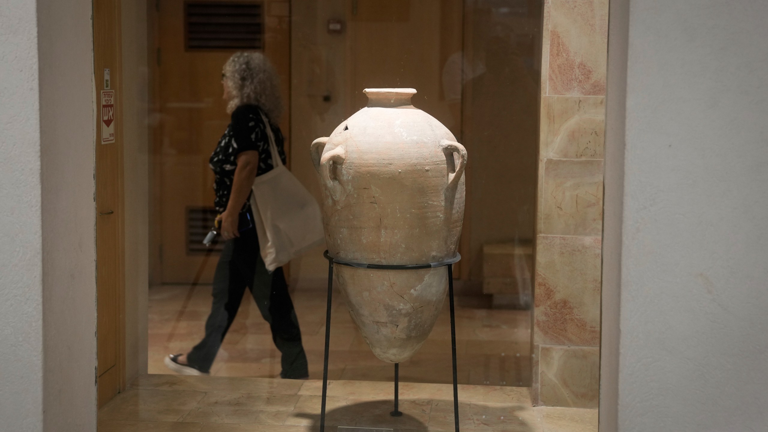 A rare bronze-era jar, newly reassembled, returned to public exhibition after a four-year-old accidentally broke the jar in August during a visit in Hecht Museum of the University of Haifa, Israel, on Wednesday, Sept. 11, 2024. (AP Photo/Mahmoud Illean)