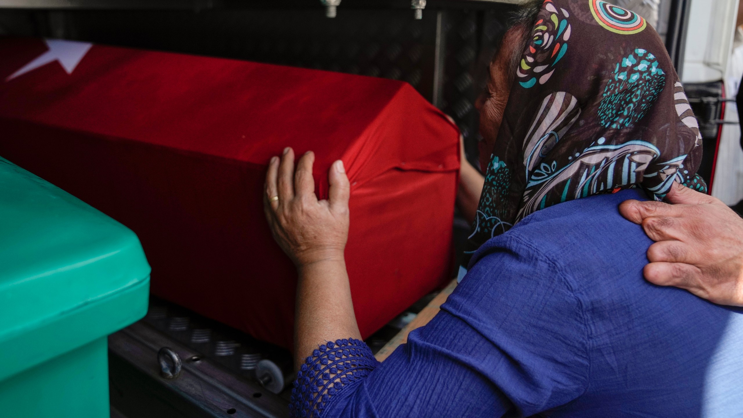 A relative of Aysenur Ezgi Eygi, a 26 year-old Turkish-American activist killed by the Israeli military, mourns over her coffin during her funeral in Didim, Turkey, Saturday, Sept. 14, 2024,(AP Photo/Khalil Hamra)