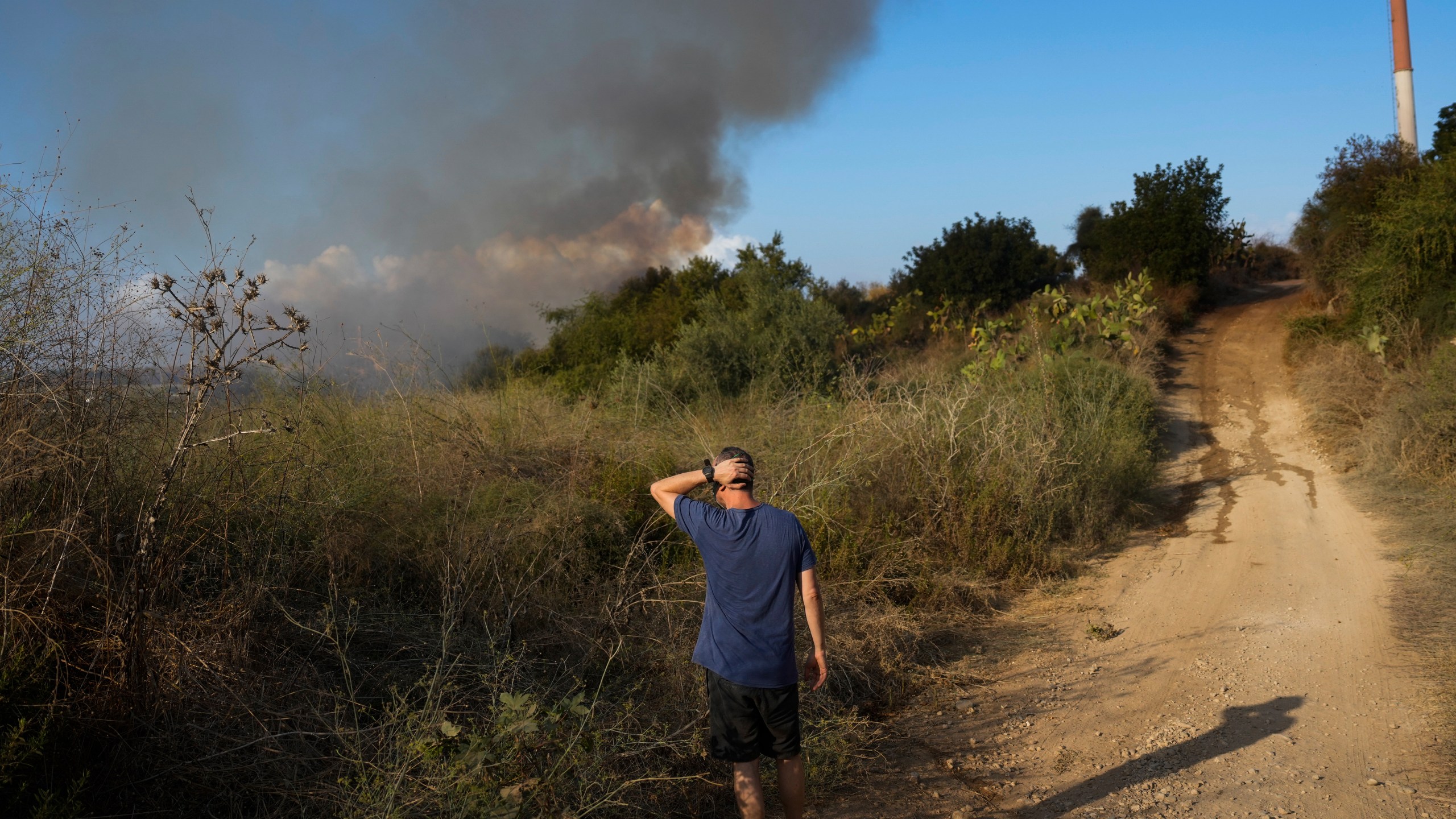 Smoke rises from a fire in central Israel after the Israeli army said a missile fired from Yemen landed in an open area on Sunday, Sept. 15, 2024. (AP Photo/Ohad Zwigenberg)