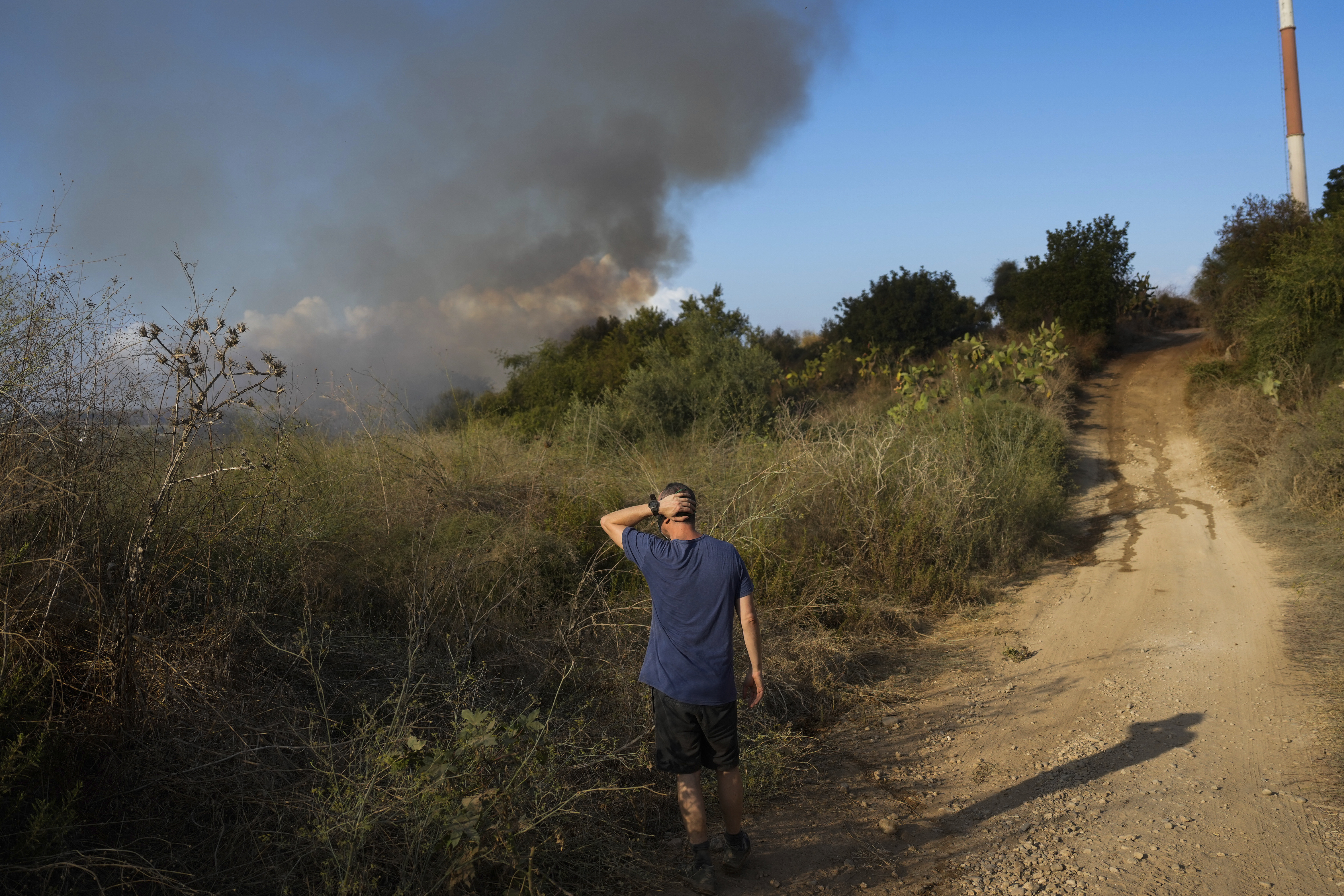 Smoke rises from a fire in central Israel after the Israeli army said a missile fired from Yemen landed in an open area on Sunday, Sept. 15, 2024. (AP Photo/Ohad Zwigenberg)