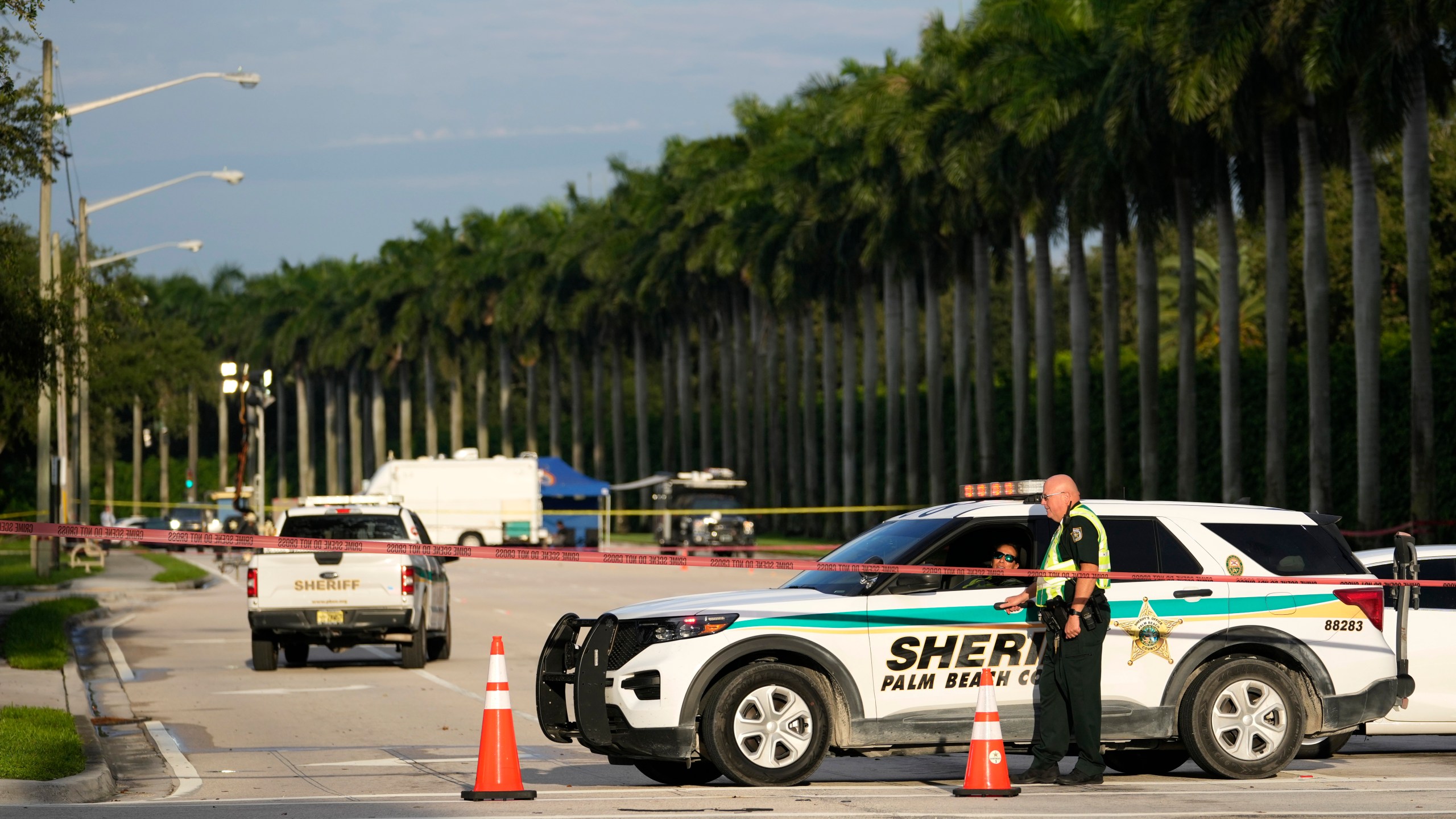 An officer with the Palm Beach County Sheriffs works outside of Trump International Golf Club after the apparent assassination attempt of Republican presidential nominee and former President Donald Trump, Monday, Sept. 16, 2024, in West Palm Beach, Fla. (AP Photo/Lynne Sladky)