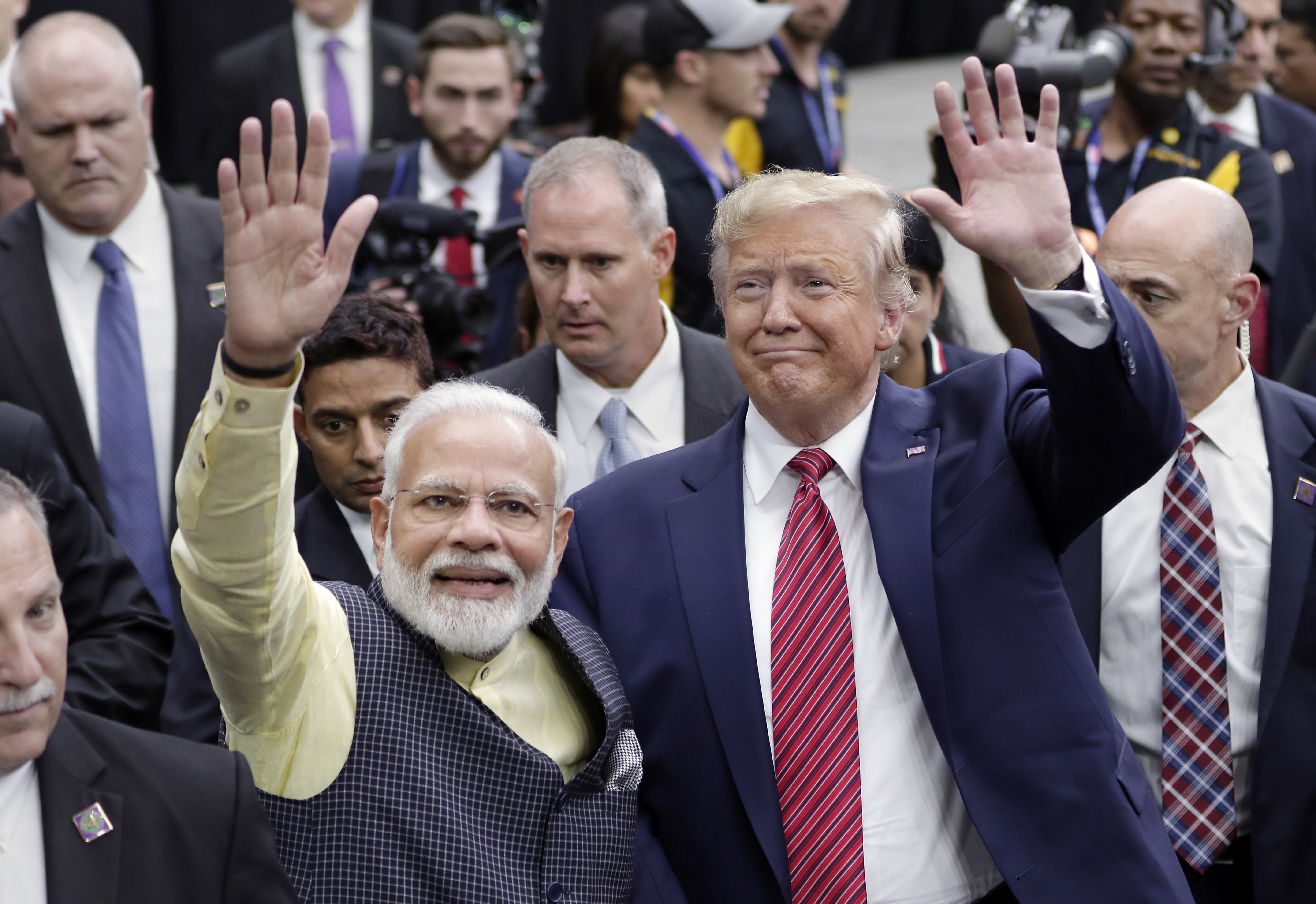 FILE - India Prime Minister Narendra Modi and then President Donald Trump walk the perimeter of the arena floor to greet attendants after Modi's speech during the "Howdi Modi" event, September 22, 2019, at NRG Stadium in Houston. Trump says he’s meeting next week with Indian Prime Minister Narendra Modi. Modi is scheduled to be in the United States this weekend hosted by President Joe Biden in his Wilmington, Delaware hometown along with leaders of Australia and Japan for a summit of the so-called Quad. (AP Photo/Michael Wyke, File)