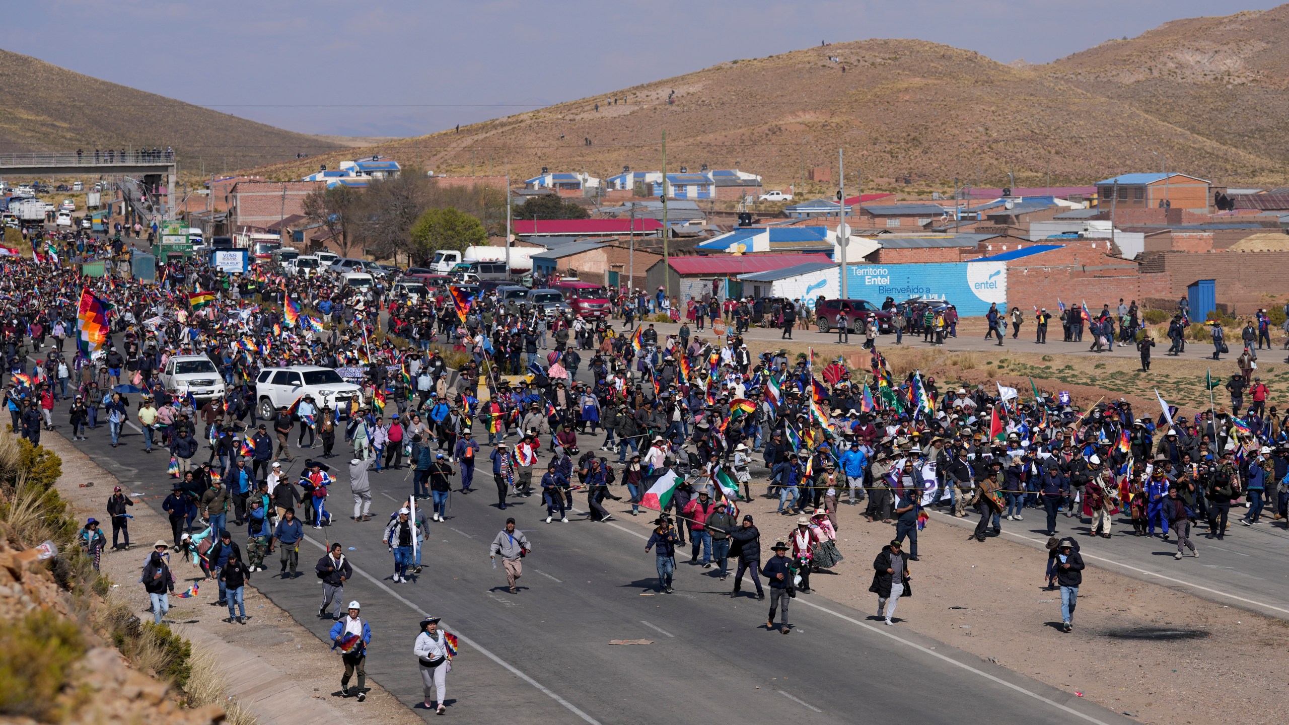 Supporters of former President Evo Morales, who are marching to the capital to protest the government of current President Luis Arce, walk toward Arce supporters who met them along the route in Vila Vila, Bolivia, Tuesday, Sept. 17, 2024. (AP Photo/Juan Karita)