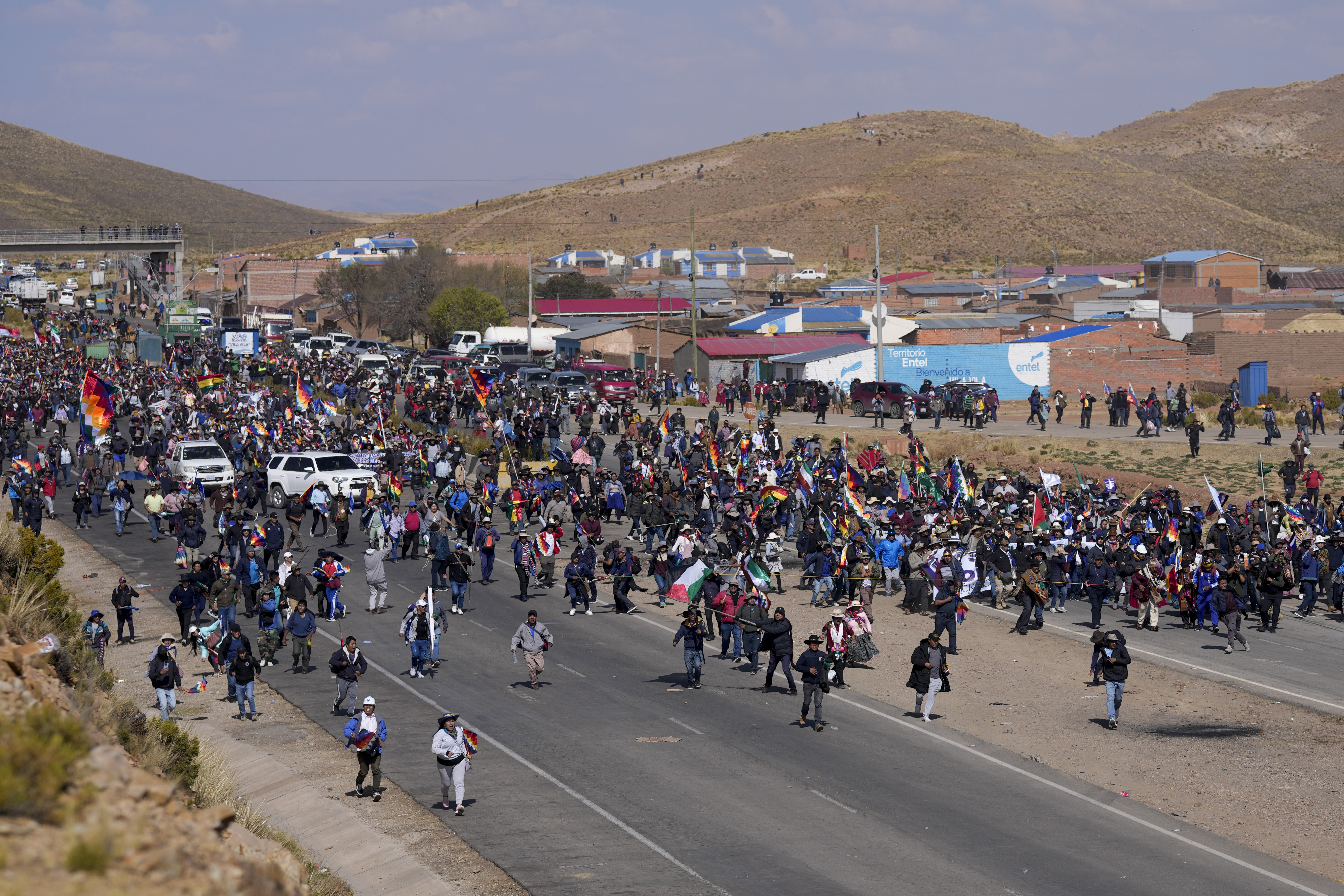 Supporters of former President Evo Morales, who are marching to the capital to protest the government of current President Luis Arce, walk toward Arce supporters who met them along the route in Vila Vila, Bolivia, Tuesday, Sept. 17, 2024. (AP Photo/Juan Karita)