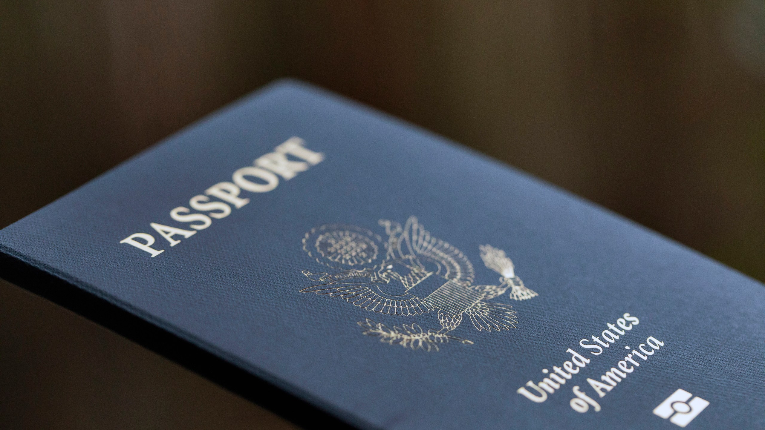 FILE - The cover of a U.S. Passport is displayed in Tigard, Ore., Dec. 11, 2021. Americans can now renew their passports online, bypassing a cumbersome mail-in paper application process that often caused delays. The State Department announced Wednesday that its online passport renewal system is now fully operational. (AP Photo/Jenny Kane, File)