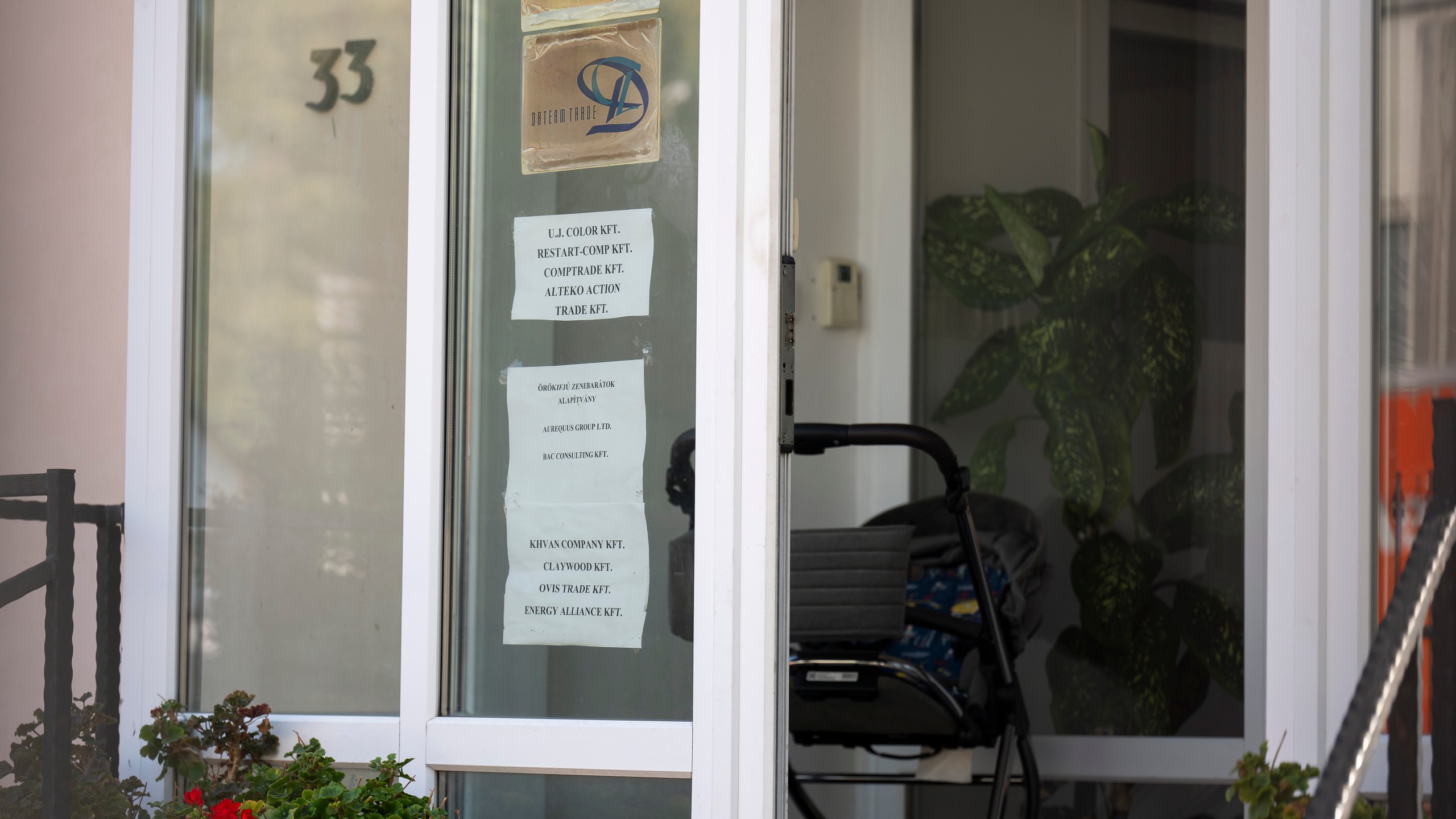 This shows a sign featuring the names of several companies on the door of a house where a Hungarian company that allegedly manufactured pagers that exploded in Lebanon and Syria is headquartered in Budapest Wednesday, Sept. 18, 2024. (AP Photo/Denes Erdos)