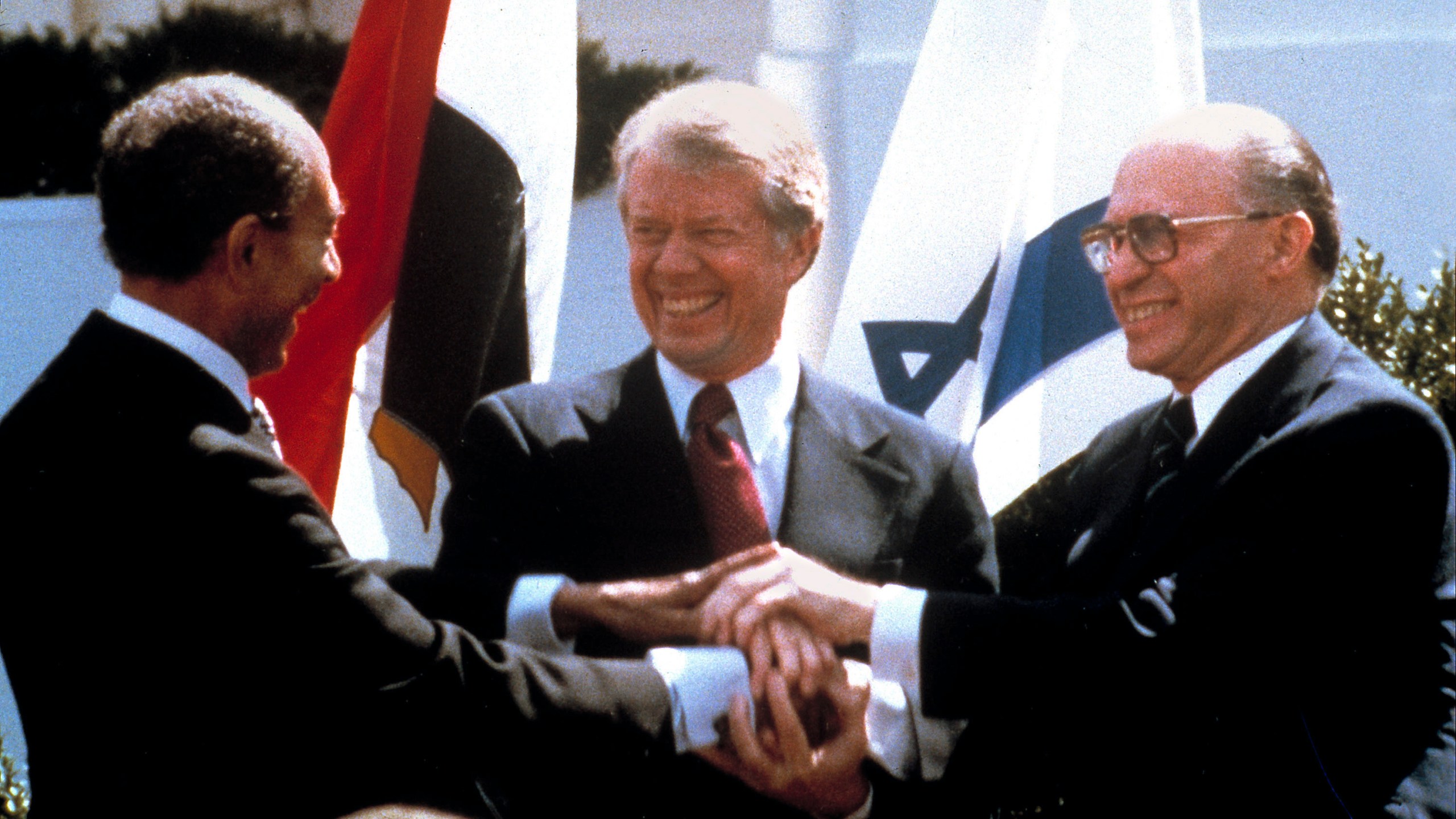 FILE - Egyptian President Anwar Sadat, left, U.S. President Jimmy Carter, center, and Israeli Prime Minister Menachem Begin clasp hands on the North lawn of the White House as they completed signing of the peace treaty between Egypt and Israel in Washington on March, 26, 1979. (AP Photo/Bob Daugherty, File)