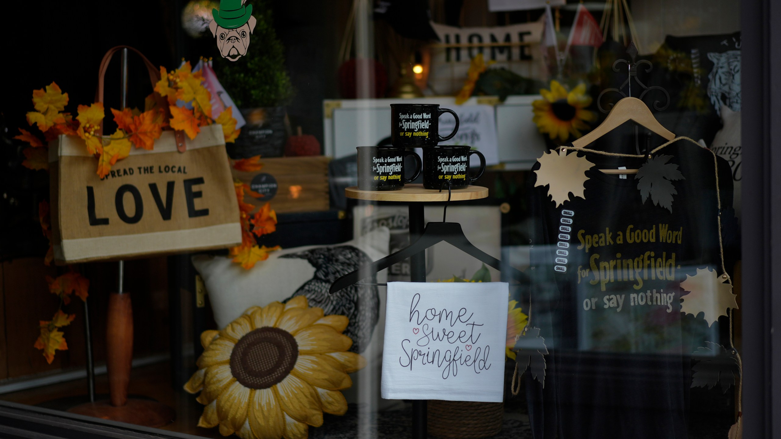 Items supporting Springfield, Ohio, including the slogan "Speak a Good Word for Springfield or say nothing," and "Hope Sweet Springfield," are displayed in the Champion City Guide & Supply shop window, Tuesday, Sept. 17, 2024, in Springfield, Ohio. (AP Photo/Carolyn Kaster)