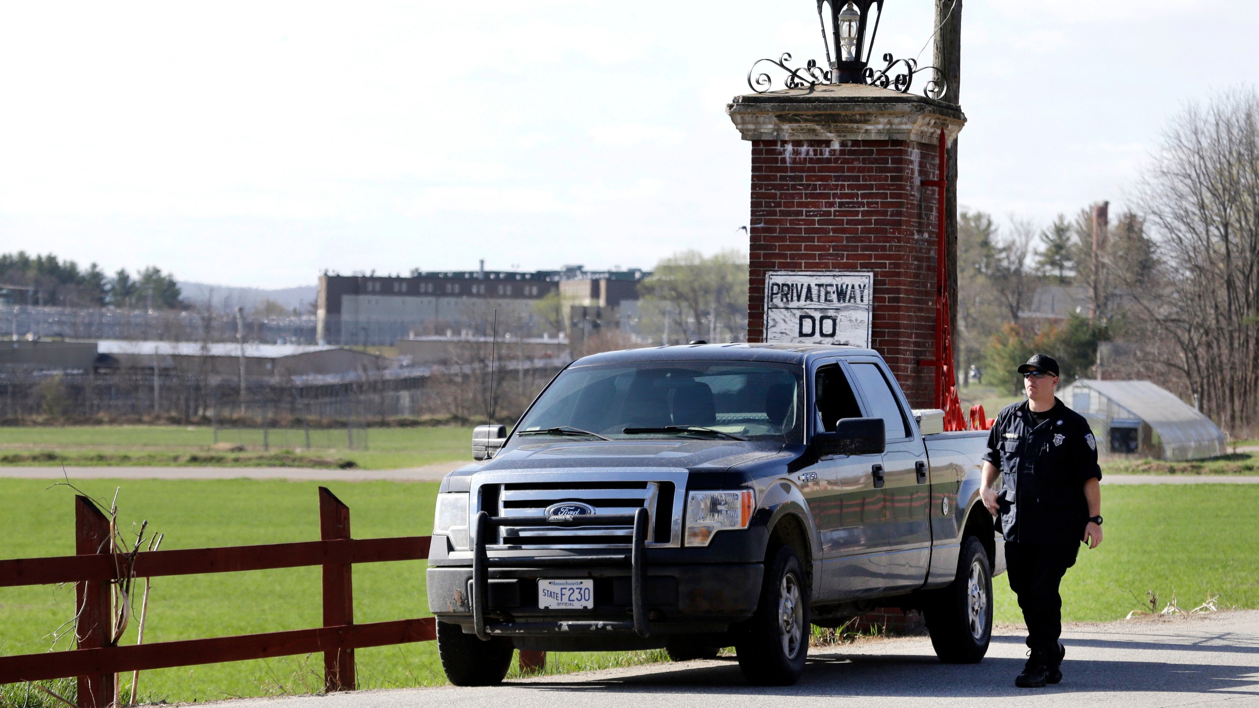 FILE - A police officer guards an entrance to the Souza-Baranowski Correctional Center, Wednesday, April 19, 2017, in Shirley, Mass. (AP Photo/Elise Amendola, File)