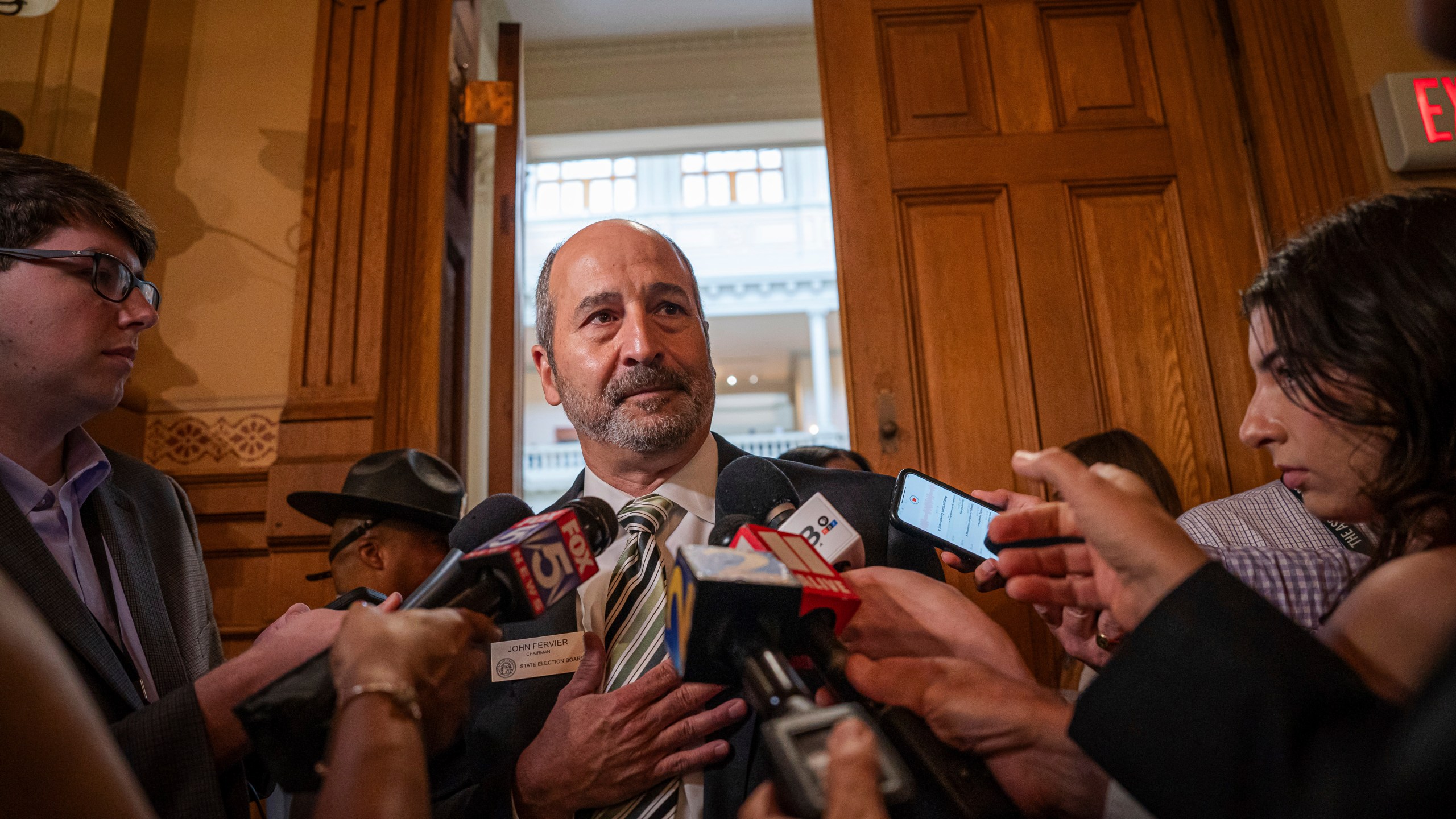 FILE - John Fervier, Chairman of the State Election Board, takes questions from the media during a brief recess during a meeting at the Capitol in Atlanta, Aug. 6, 2024. (Matthew Pearson/WABE via AP, File)