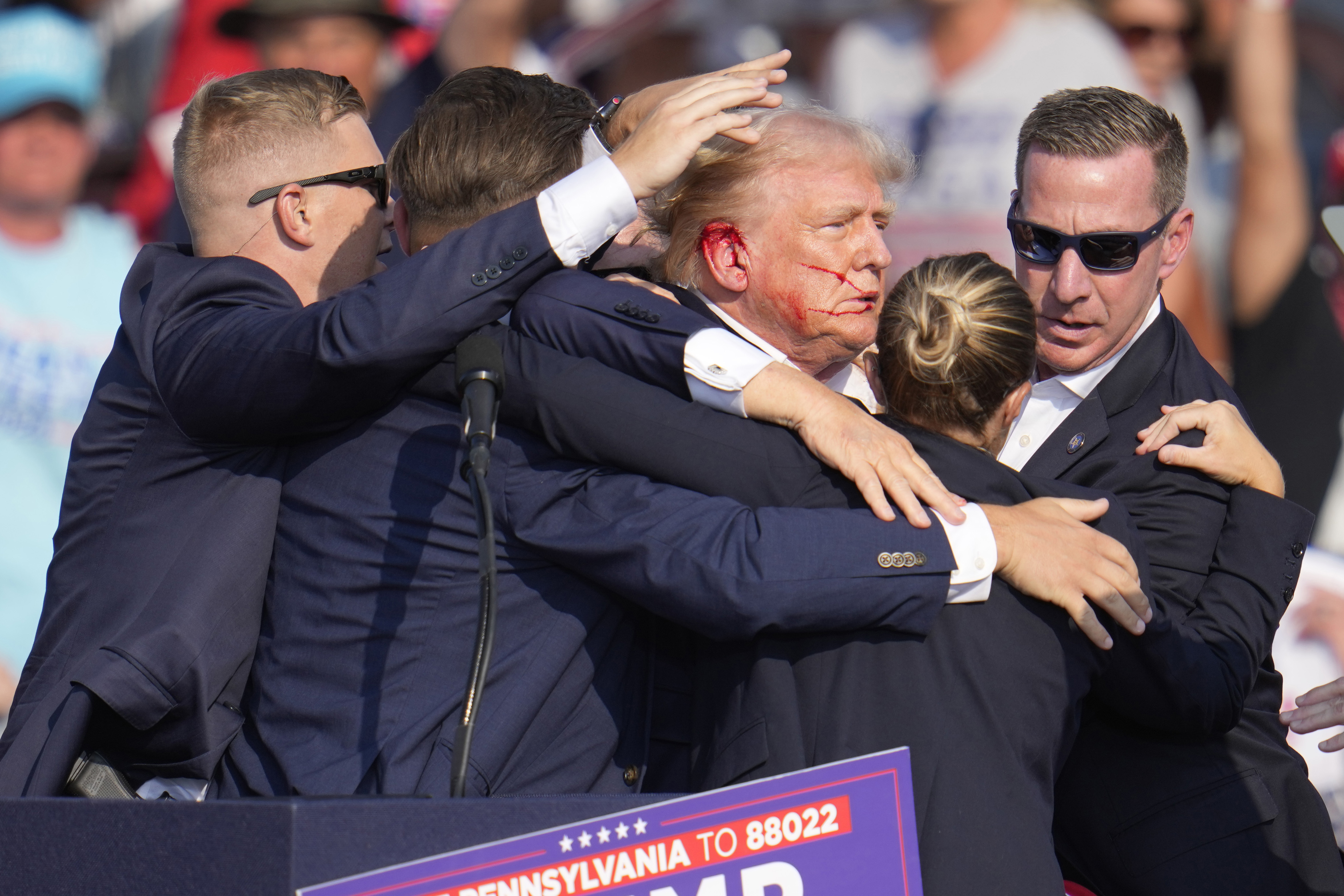 FILE - Republican presidential candidate former President Donald Trump is surrounded by U.S. Secret Service agents as he is helped off the stage at a campaign rally in Butler, Pa., July 13, 2024. (AP Photo/Gene J. Puskar, File)