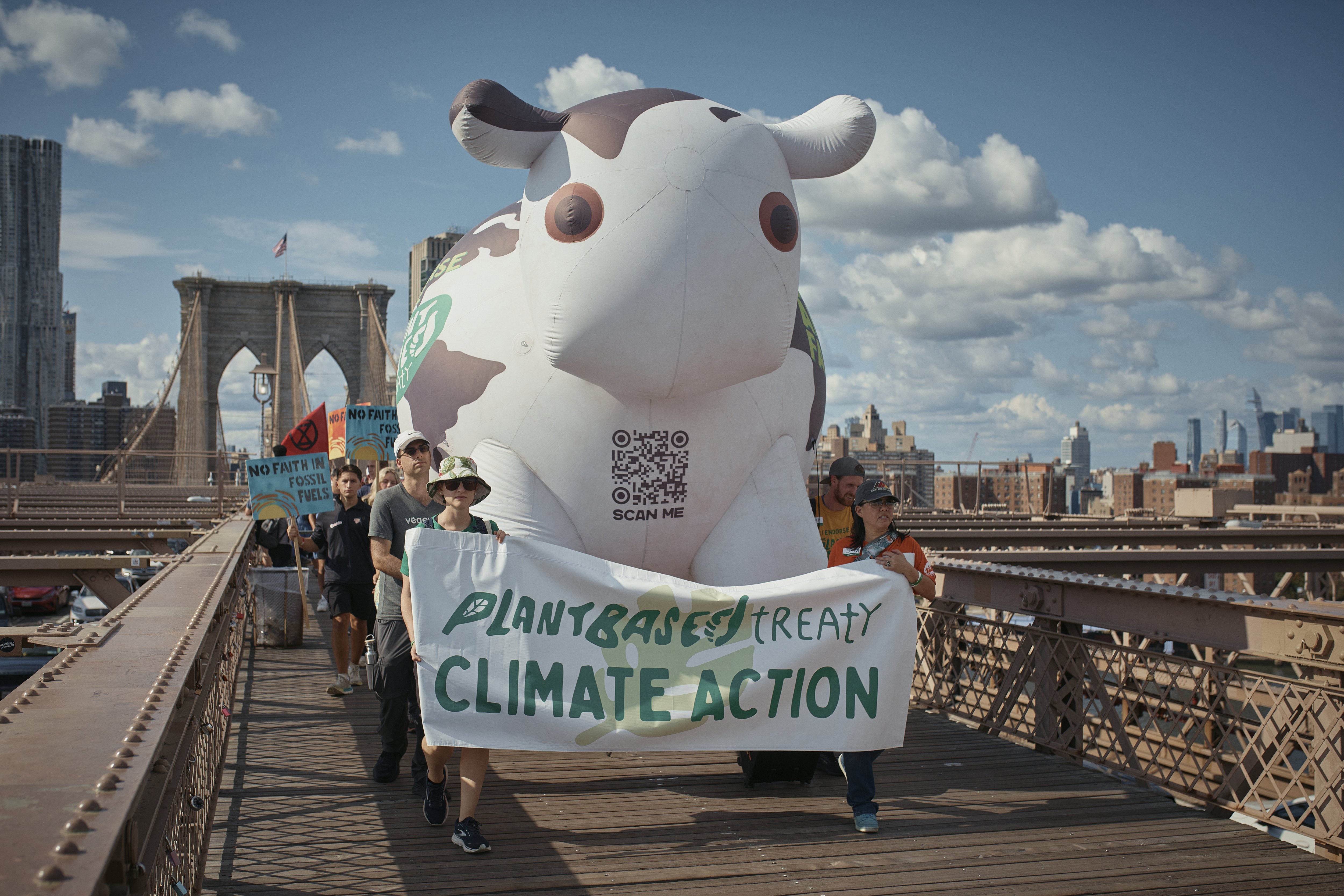 Protesters cross the Brooklyn Bridge during a Youth Climate Strike march to demand an end to the era of fossil fuels, Friday, Sept. 20, 2024, in New York. (AP Photo/Andres Kudacki)