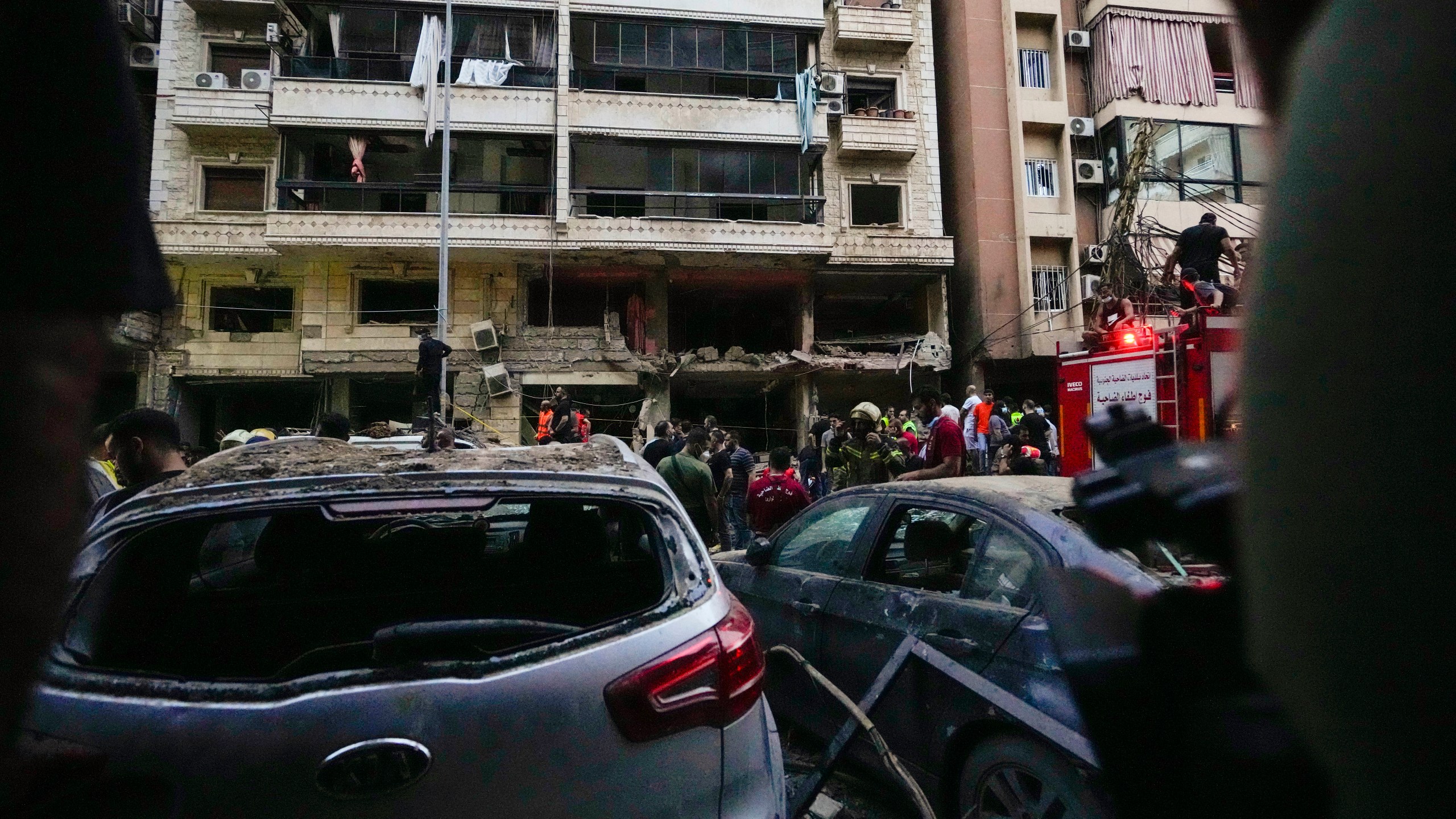 Rescuers work at the scene of an Israeli missile strike in the southern suburbs of Beirut, Friday, Sept. 20, 2024. (AP Photo/Hassan Ammar)