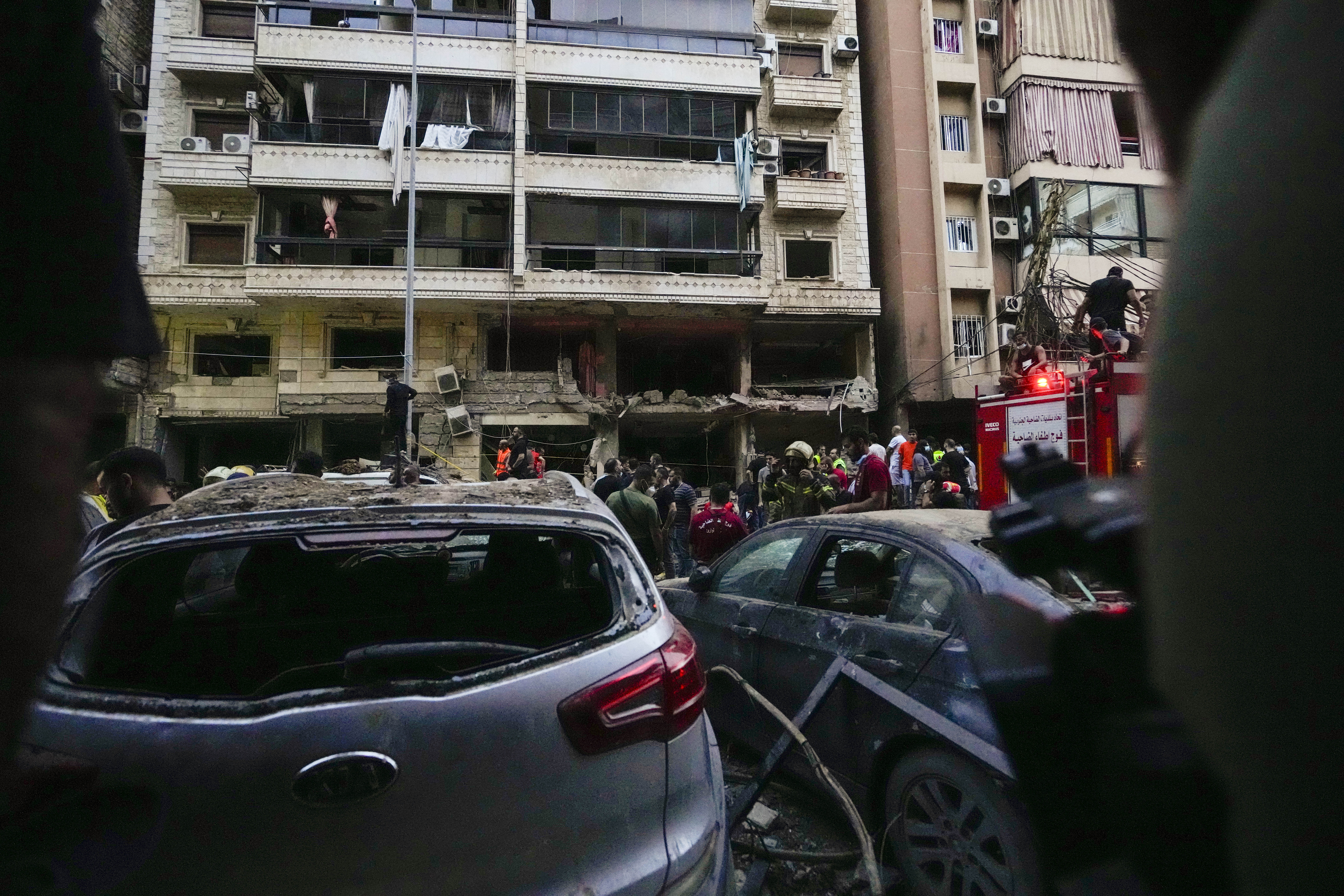 Rescuers work at the scene of an Israeli missile strike in the southern suburbs of Beirut, Friday, Sept. 20, 2024. (AP Photo/Hassan Ammar)