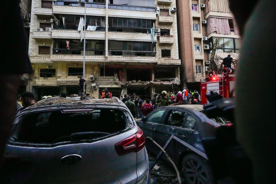 Rescuers work at the scene of an Israeli missile strike in the southern suburbs of Beirut, Friday, Sept. 20, 2024. (AP Photo/Hassan Ammar)