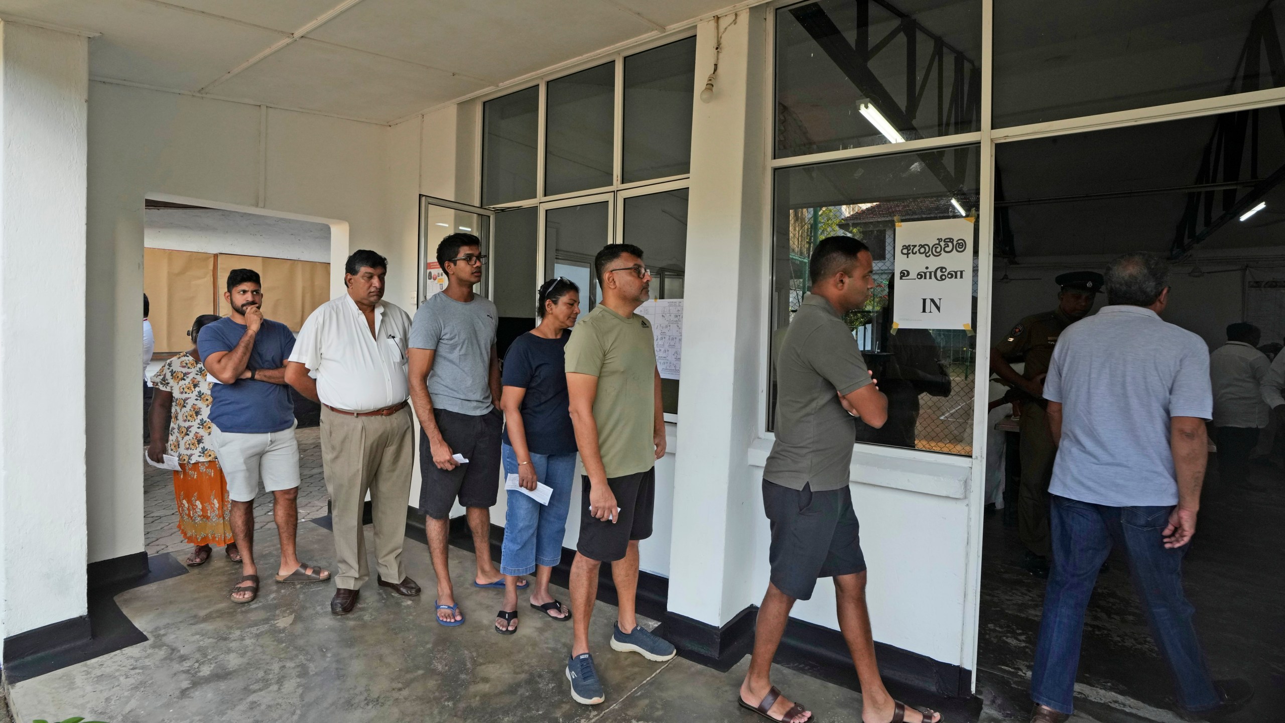 People wait in a queue to casts their votes at a polling station in Colombo, Sri Lanka, Saturday, Sept. 21, 2024. (AP Photo/Rajesh Kumar Singh)