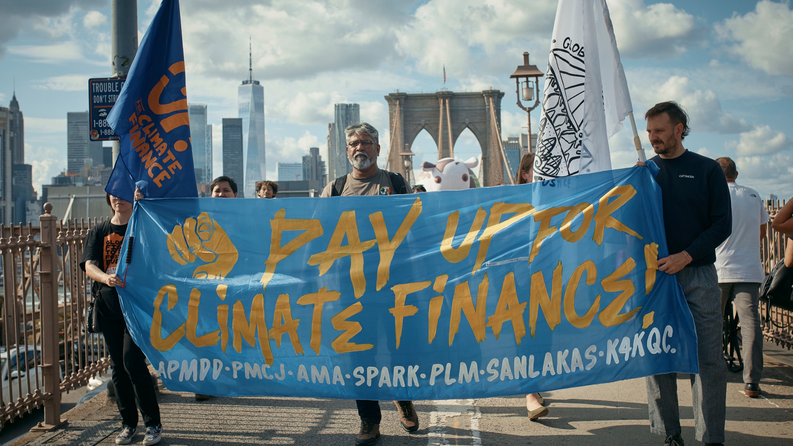 Protesters cross the Brooklyn Bridge during a Youth Climate Strike march to demand an end to the era of fossil fuels, Friday, Sept. 20, 2024, in New York. (AP Photo/Andres Kudacki)