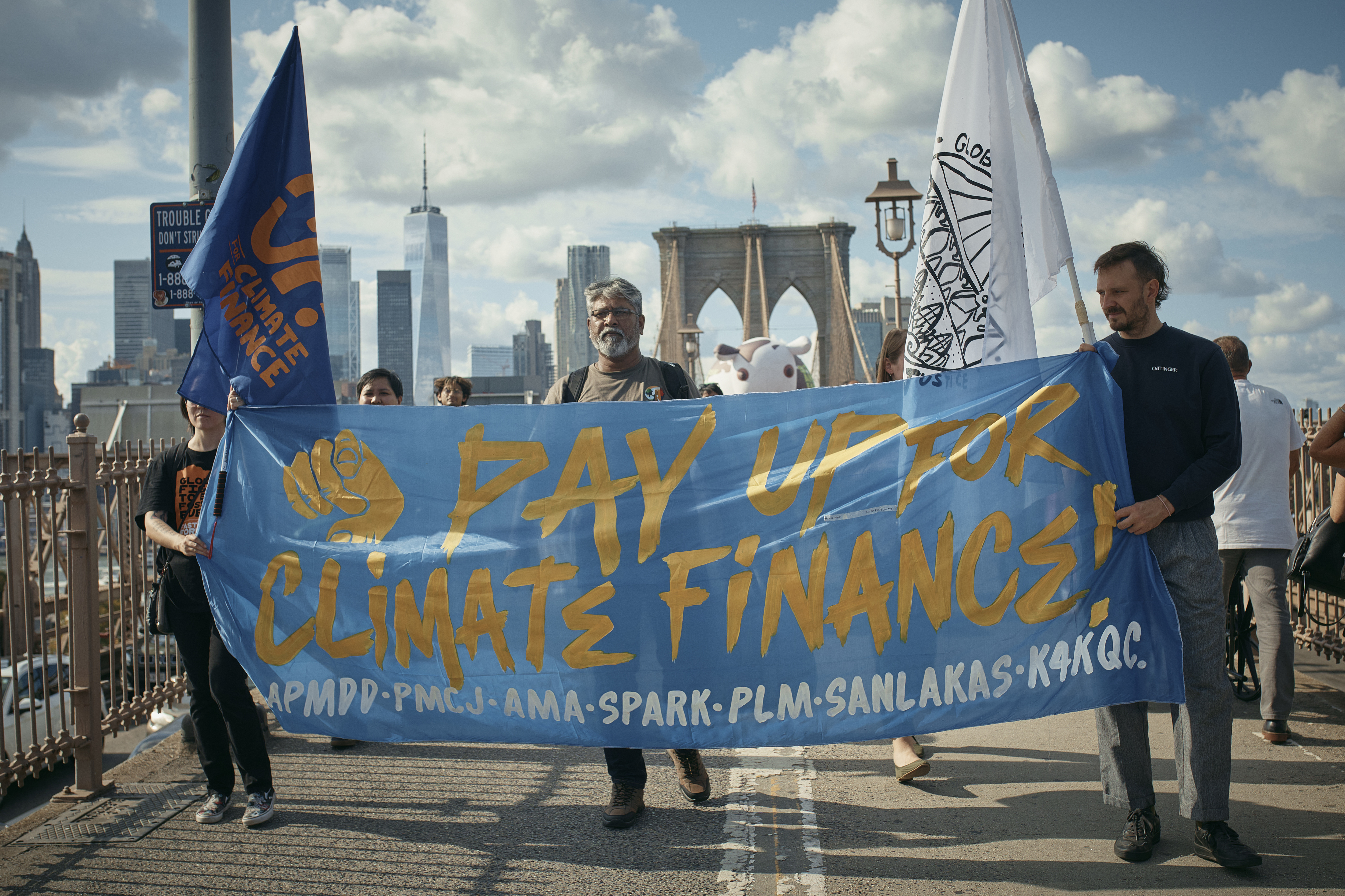 Protesters cross the Brooklyn Bridge during a Youth Climate Strike march to demand an end to the era of fossil fuels, Friday, Sept. 20, 2024, in New York. (AP Photo/Andres Kudacki)