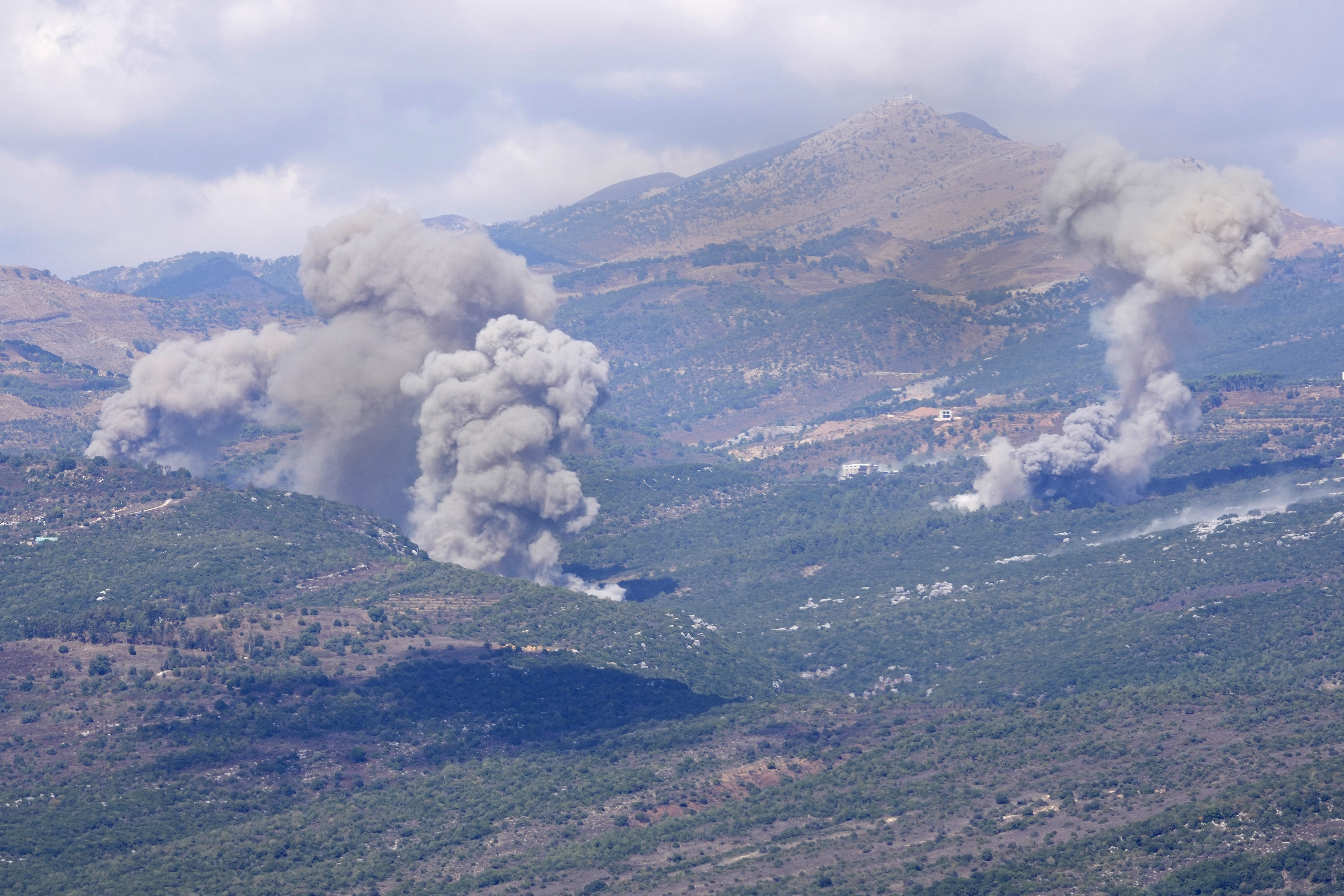 Smoke rises from Israeli airstrikes that hit Al-Rihan mountain, as seen from Marjayoun town, south Lebanon, Saturday, Sept. 21, 2024. (AP Photo/Hussein Malla)