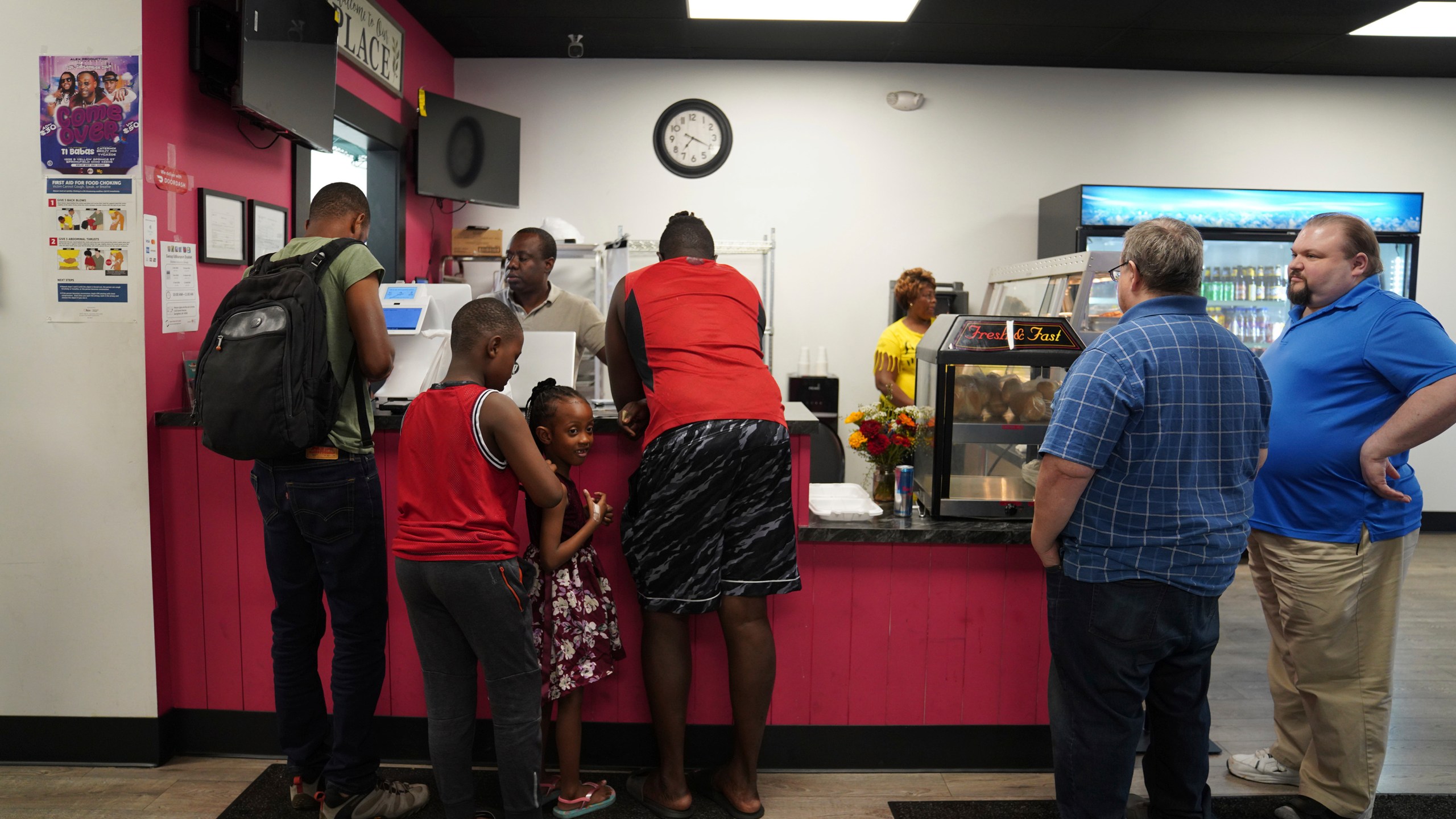 Romane Pierre of Rose Goute Creole Restaurant in Springfield, Ohio, helps a line of customers, Monday, Sept. 16, 2024. (AP Photo/Jessie Wardarski)