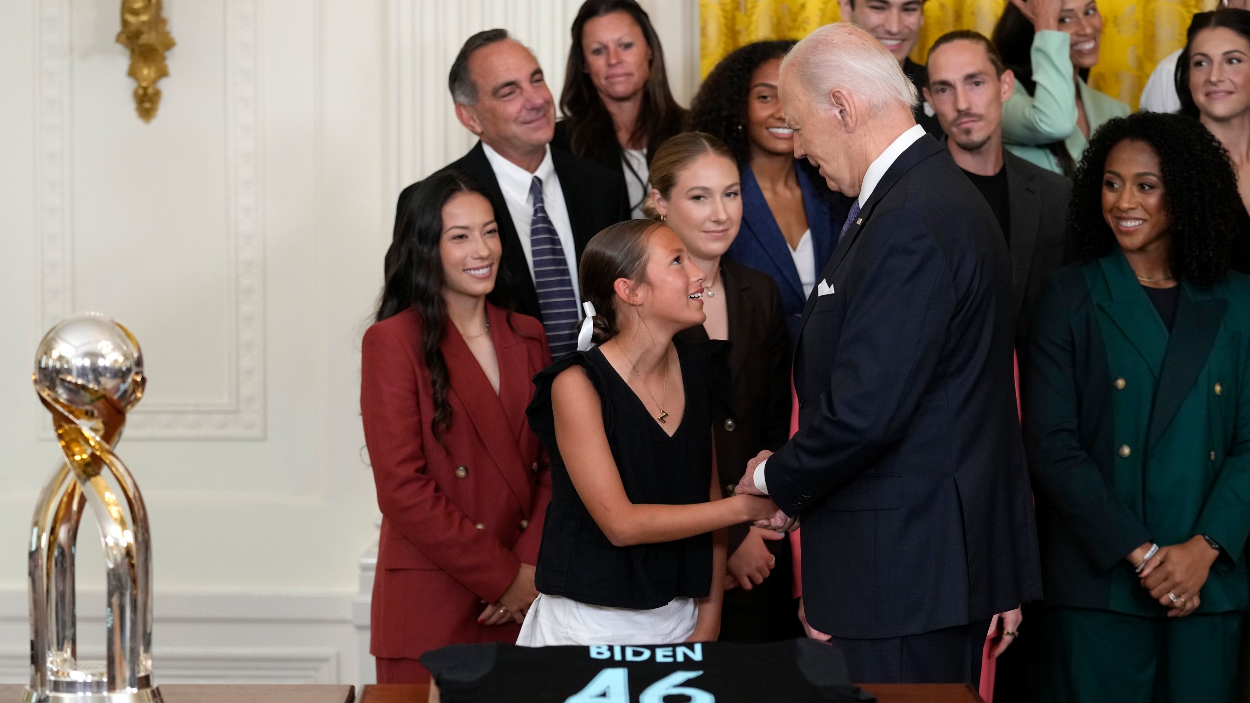 President Joe Biden greets a young girl during an event in the East Room of the White House in Washington, Monday, Sept. 23, 2024, to welcome the NJ/NY Gotham FC and celebrate their 2023 NWSL championship. (AP Photo/Susan Walsh)