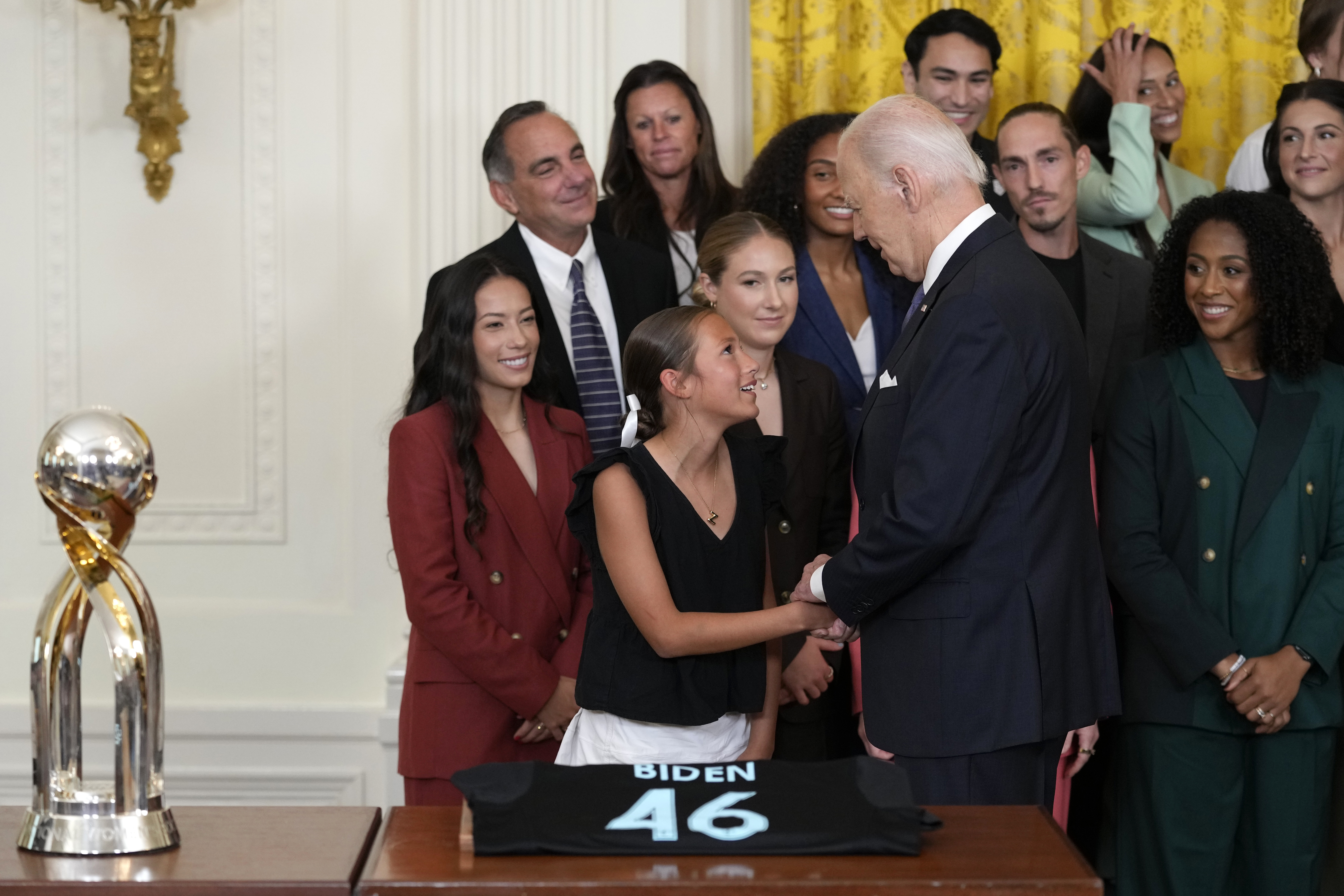 President Joe Biden greets a young girl during an event in the East Room of the White House in Washington, Monday, Sept. 23, 2024, to welcome the NJ/NY Gotham FC and celebrate their 2023 NWSL championship. (AP Photo/Susan Walsh)