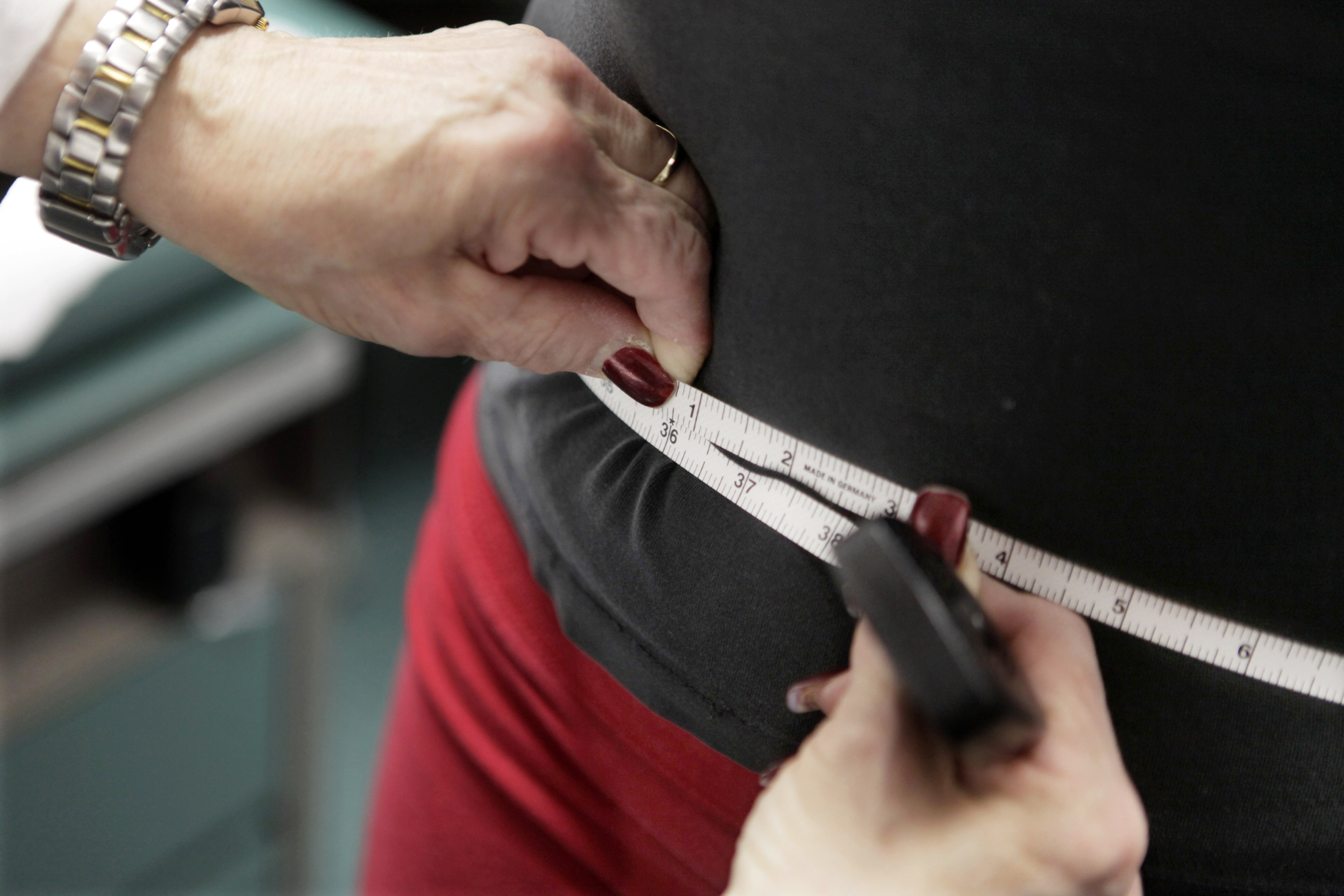 FILE - A subject's waist is measured during an obesity prevention study in Chicago on Jan. 20, 2010. (AP Photo/M. Spencer Green, File)