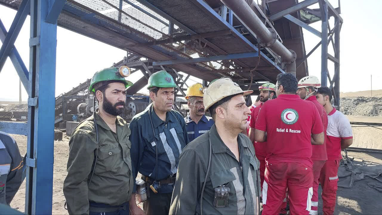 In this photo released on Tuesday, Sept. 24, 2024, by Iranian Interior Ministry, miners and rescue personnel stand at the site of a coal mine where methane leak sparked an explosion on Saturday, in Tabas, some 335 miles (540 kilometers) southeast of the capital Tehran, Iran. (Iranian Interior Ministry via AP).