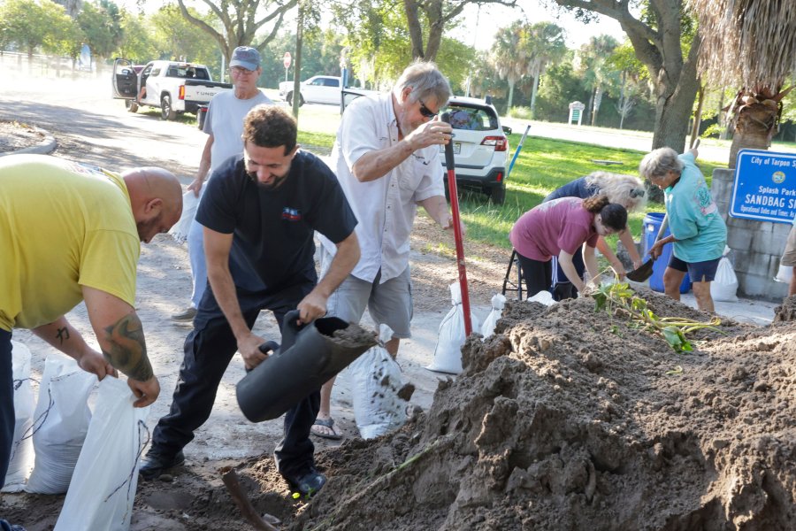 Sandbags are filled at a public site while residents prepare their homes for potential flooding, Tuesday, Sept. 24, 2024, in Tarpon Springs, Fla., as Tropical Storm Helene approaches. (Douglas R. Clifford/Tampa Bay Times via AP)