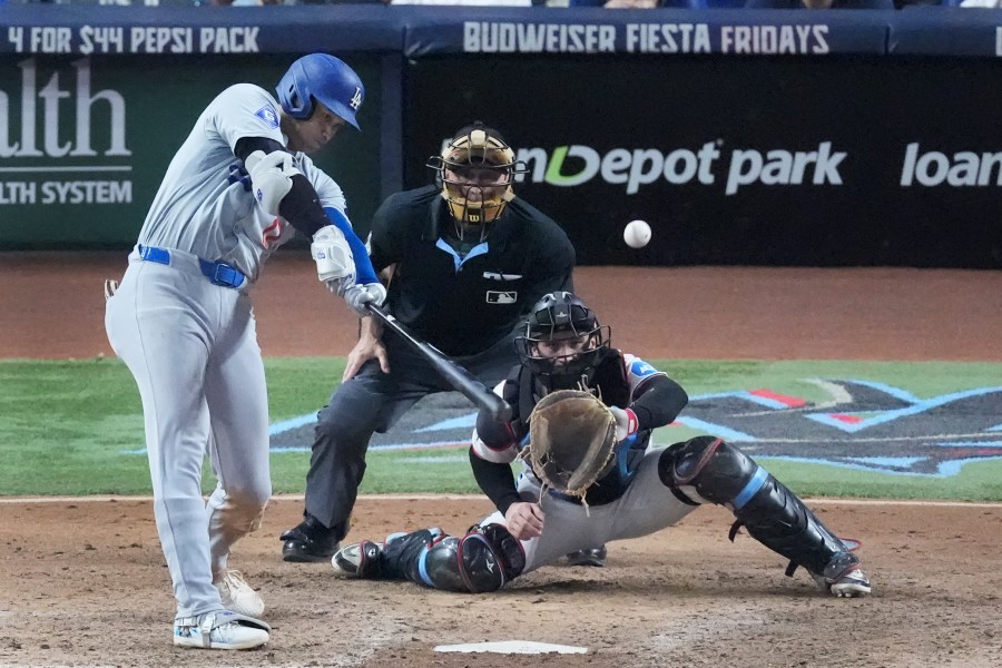 Los Angeles Dodgers' Shohei Ohtani (17) hits a home run scoring Andy Pages, during the seventh inning of a baseball game against the Miami Marlins, Thursday, Sept. 19, 2024, in Miami. (AP Photo/Wilfredo Lee)