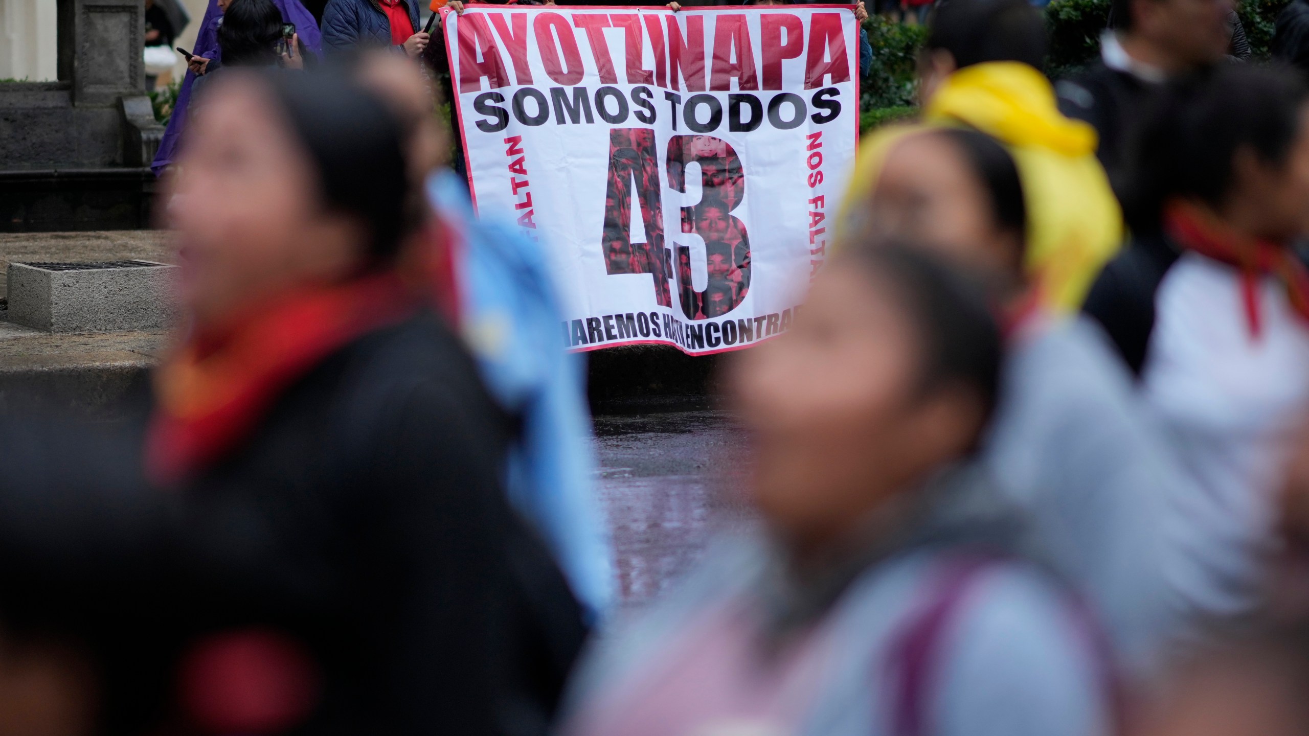 Families and friends take part in a demonstration marking the 10-year anniversary of the disappearance of 43 students from an Ayotzinapa rural teacher's college, in Mexico City, Thursday, Sept. 26, 2024. (AP Photo/Eduardo Verdugo)