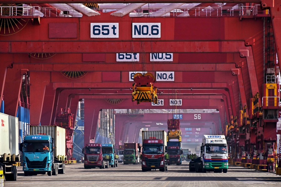 FILE - In this photo released by Xinhua News Agency, containers are unloaded from a cargo ship at Qingdao Port, east China's Shandong Province on Feb. 11, 2024. (Li Ziheng/Xinhua via AP, File)