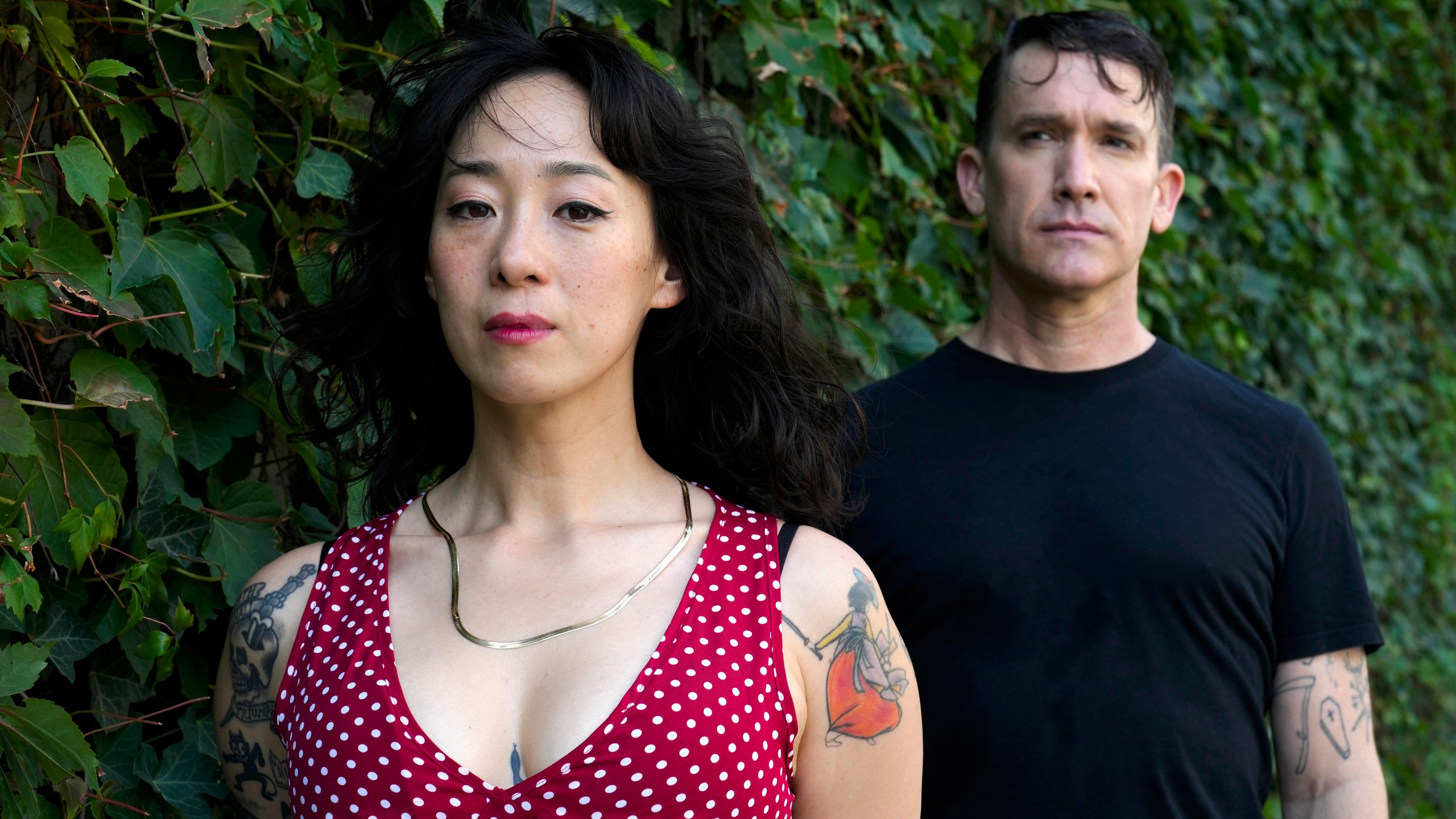 Angela Seo, left, and Jamie Stewart of the band Xiu Xiu pose for a portrait in Berlin, Germany, Wednesday, Aug. 28, 2024. (AP Photo/Markus Schreiber)