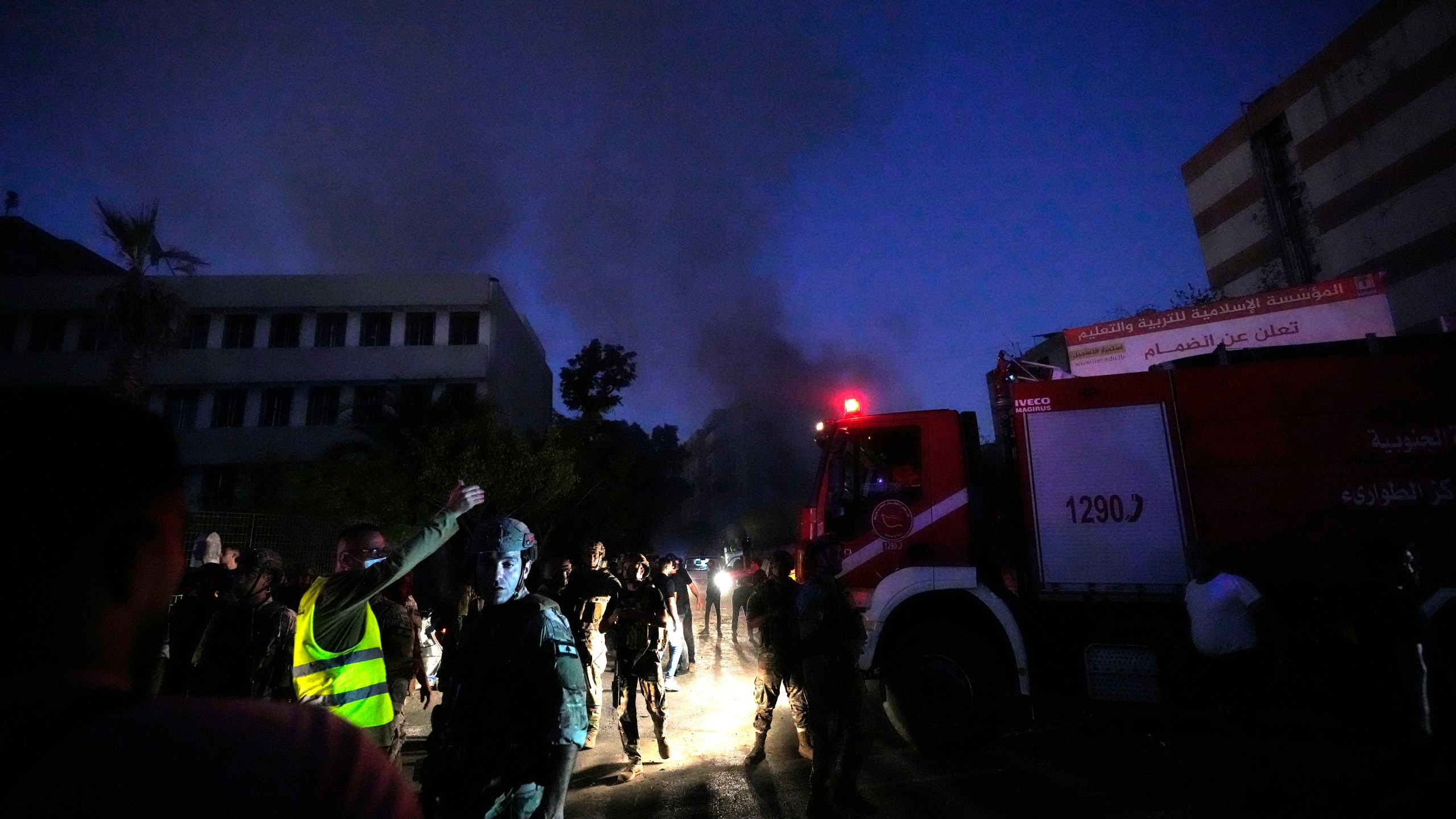 Rescuers arrive near the site of an Israeli airstrike in Beirut's southern suburbs, Friday, Sept. 27, 2024. (AP Photo/Hassan Ammar)