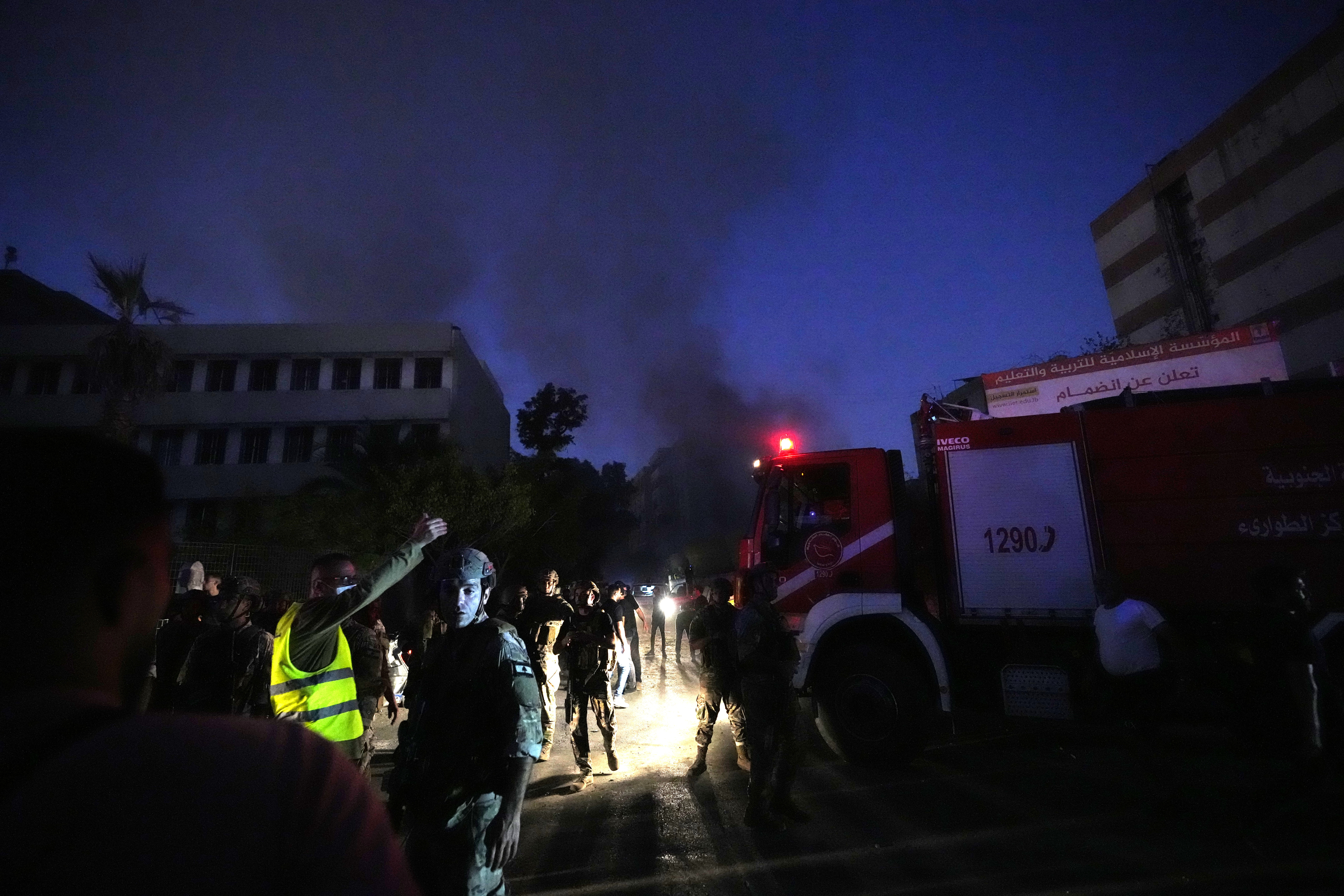 Rescuers arrive near the site of an Israeli airstrike in Beirut's southern suburbs, Friday, Sept. 27, 2024. (AP Photo/Hassan Ammar)