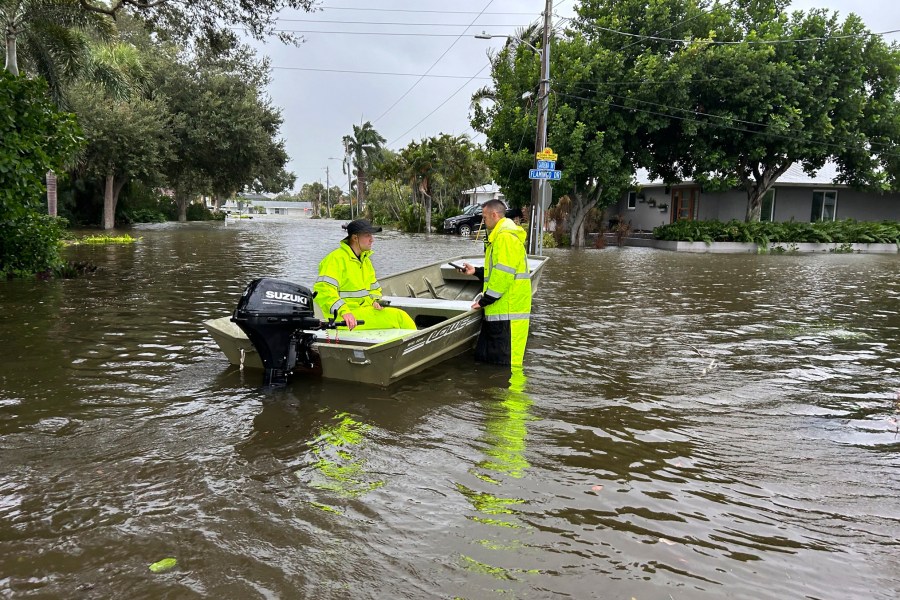 This photo provided by Venice Police Department rescue crews assist residents after conducting door-to-door wellness checks, in coastal areas that were flooded by Hurricane Helene on Friday, Sept. 27, 2024 in Venice, Fla . (Venice Police Department via AP)