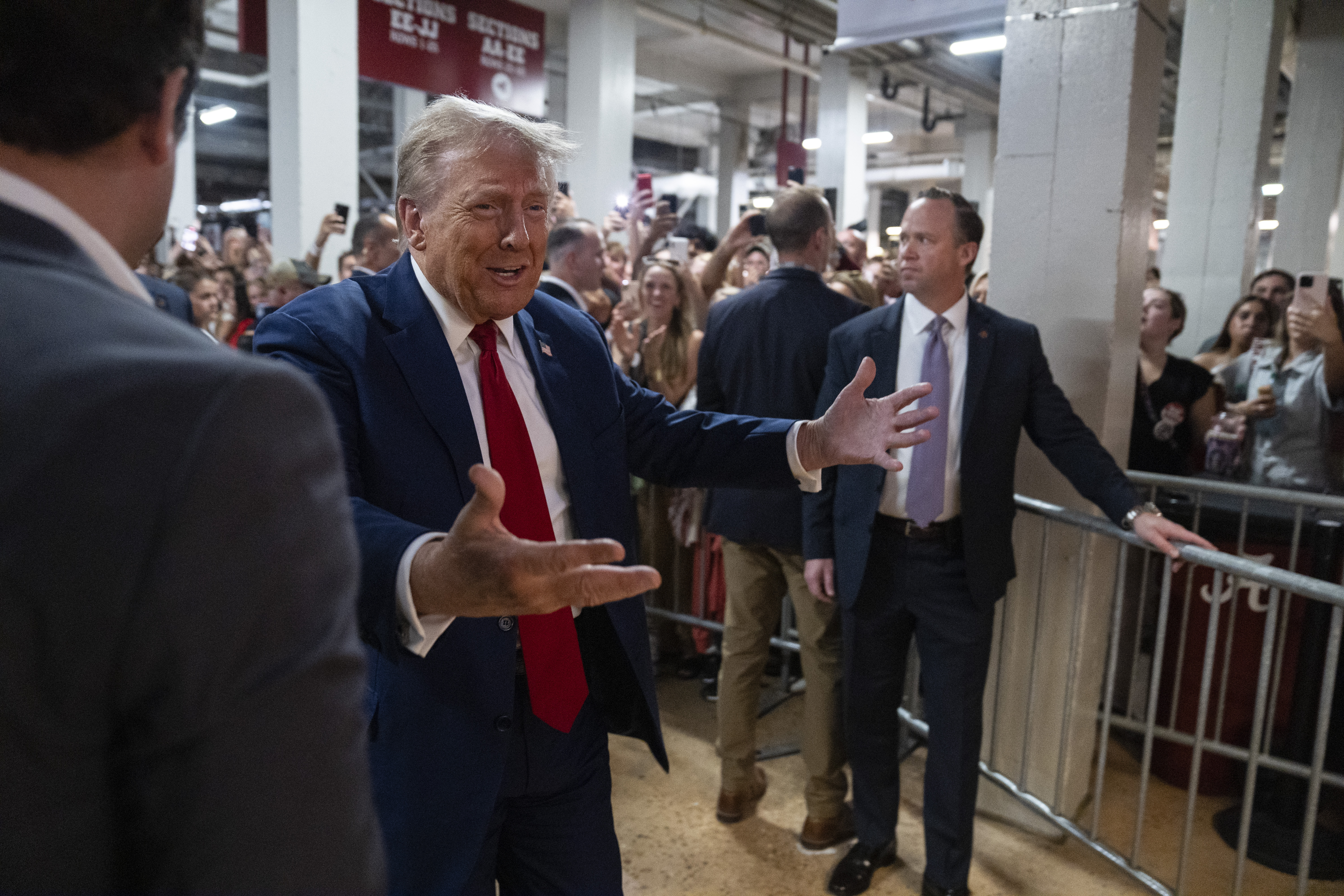 Republican presidential nominee former President Donald Trump walks to a concession stand during the Georgia vs. Alabama football game at Bryant-Denny Stadium, Saturday, Sept. 28, 2024, in Tuscaloosa, Ala. (AP Photo/Evan Vucci)