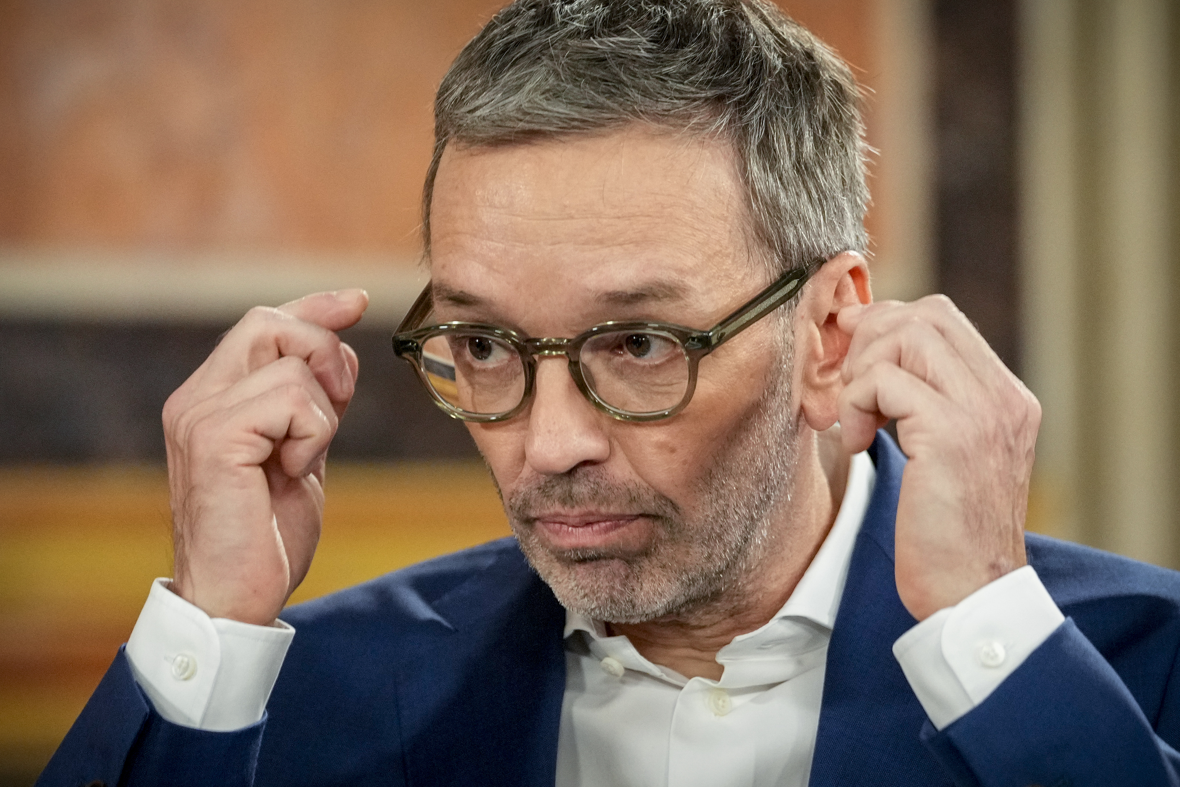 Herbert Kickl, leader of the Freedom Party of Austria adjusts his glasses at the national broadcaster studio, set up in the parliament building, in Vienna, Austria, Sunday, Sept. 29, 2024, after polls closed in the country's national election. (AP Photo/Andreea Alexandru)