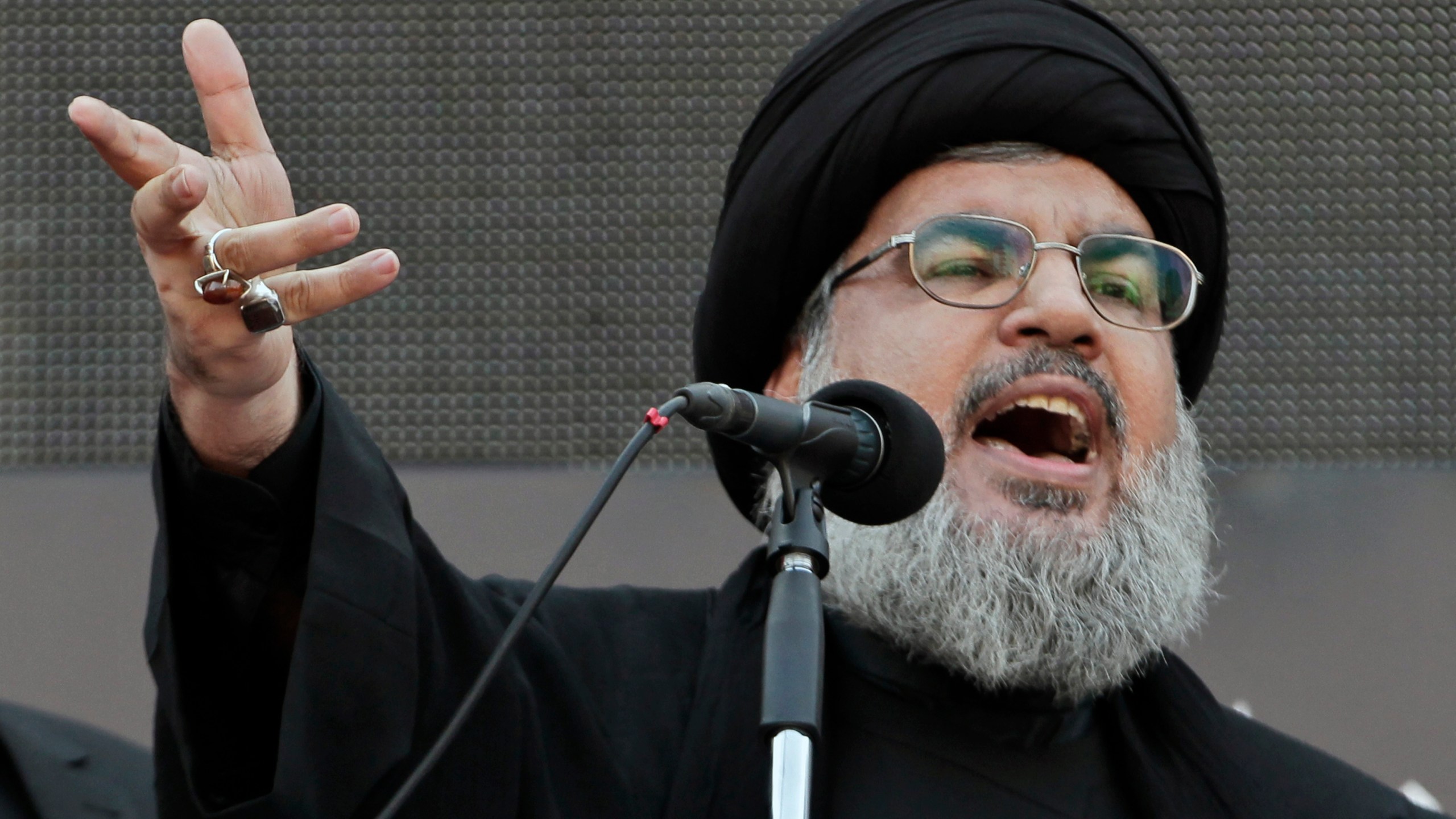 FILE - Hezbollah leader Sheik Hassan Nasrallah, speaks to the crowd in a rare public appearance during Ashura, that marks the death of Shiite Islam's Imam Hussein, in the suburbs of Beirut, Nov. 14, 2013. (AP Photo/Bilal Hussein, File)