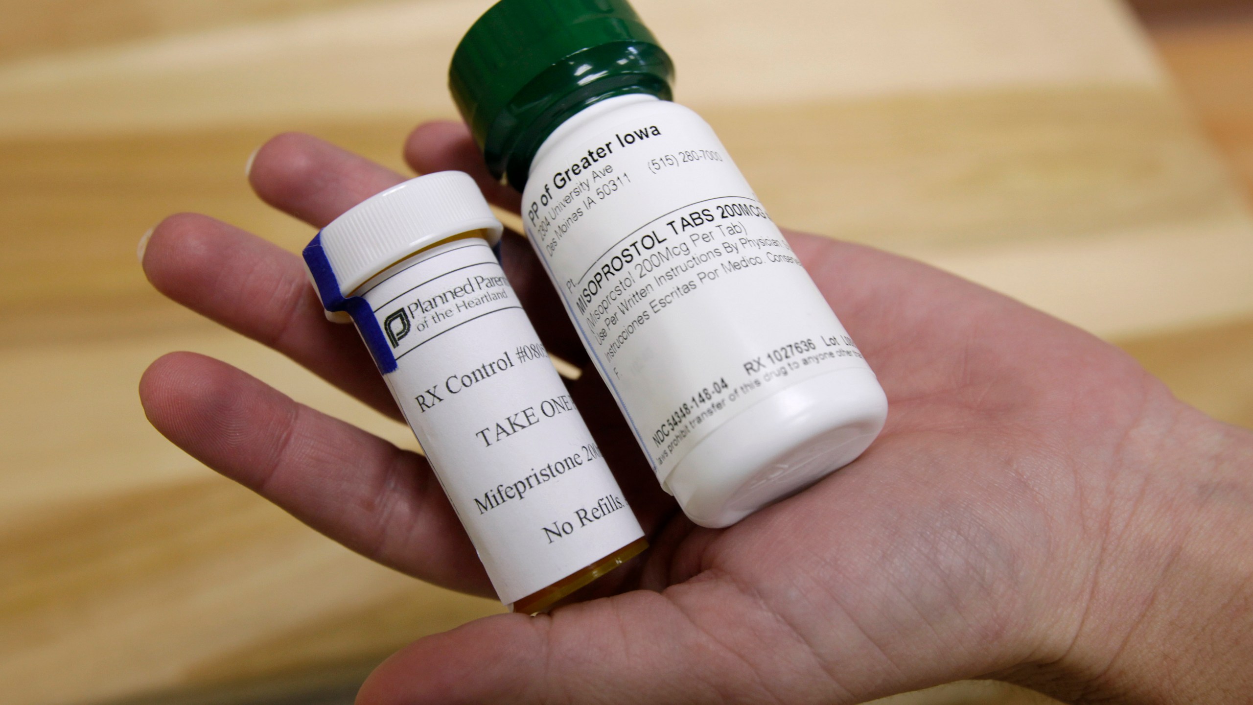 FILE - Bottles of abortion pills mifepristone, left, and misoprostol, right, are displayed at a clinic in Des Moines, Iowa, Sept. 22, 2010. (AP Photo/Charlie Neibergall, File)