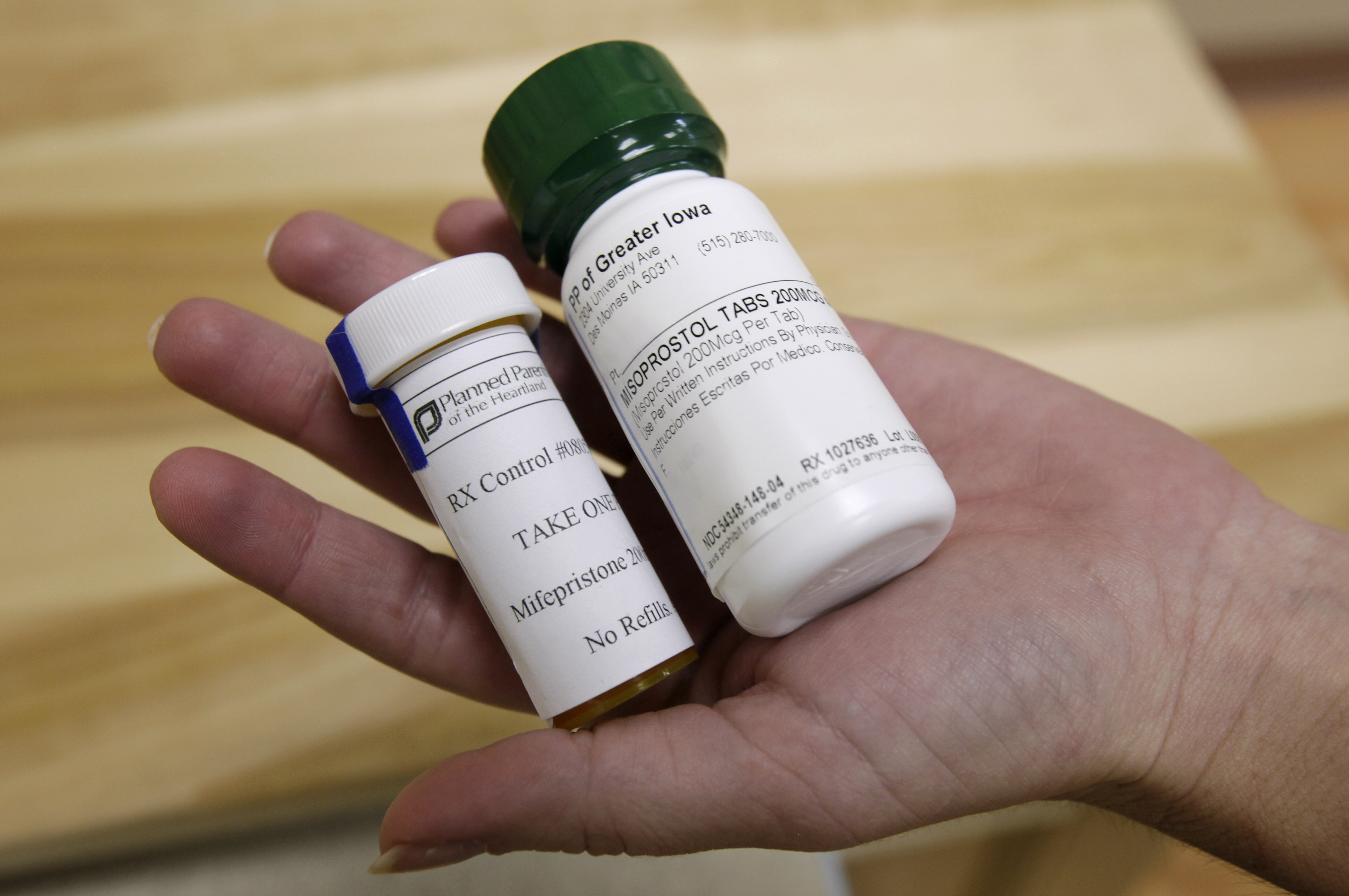 FILE - Bottles of abortion pills mifepristone, left, and misoprostol, right, are displayed at a clinic in Des Moines, Iowa, Sept. 22, 2010. (AP Photo/Charlie Neibergall, File)