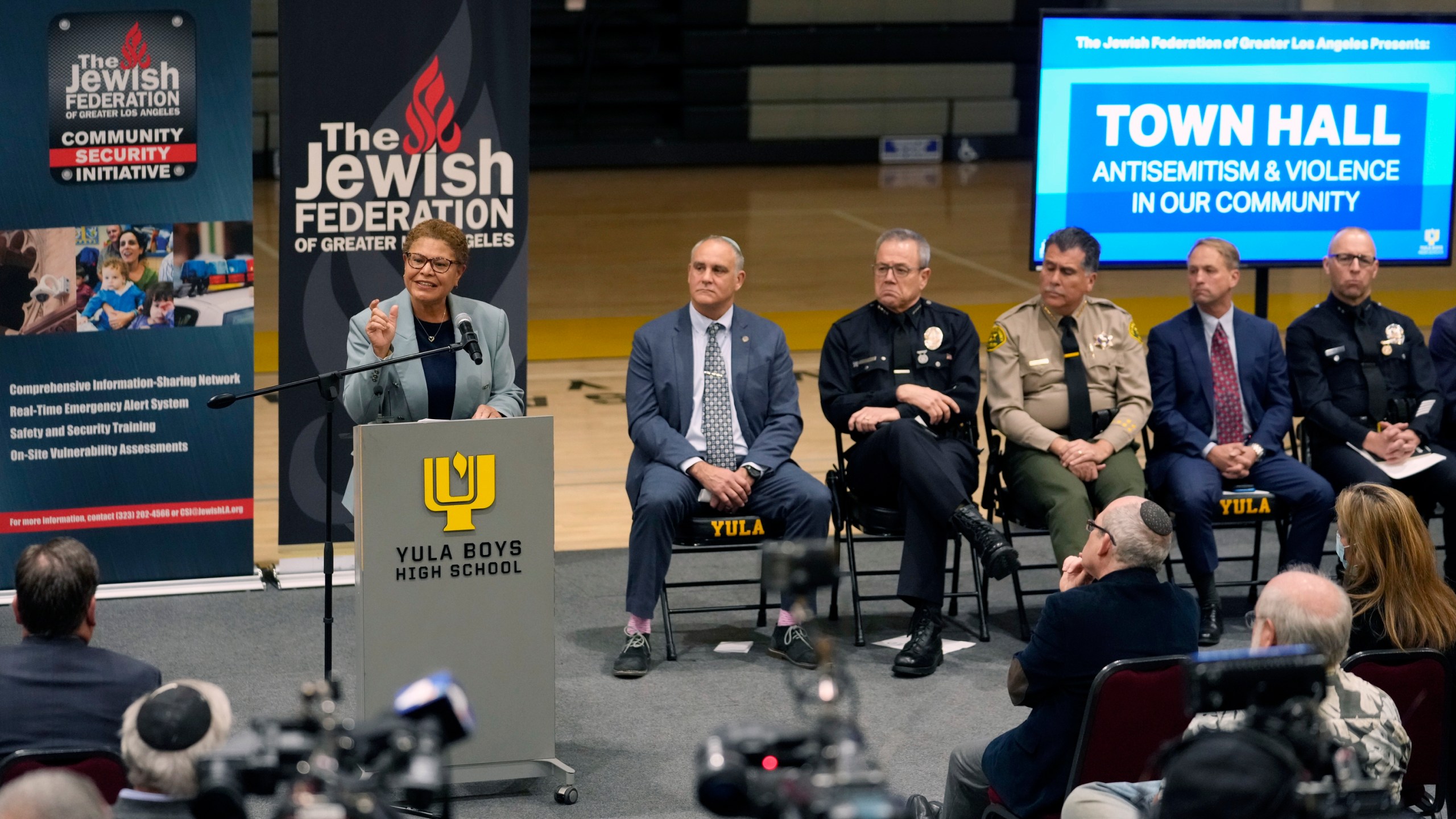 FILE - Los Angeles Mayor Karen Bass, at podium, addresses community members and other local, state law enforcement officials in a town hall on antisemitic violence at YULA Boys High School in Los Angeles Monday, Feb. 20, 2023. (AP Photo/Damian Dovarganes, File)