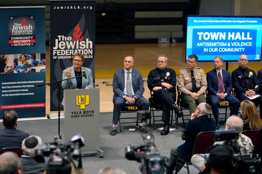 FILE - Los Angeles Mayor Karen Bass, at podium, addresses community members and other local, state law enforcement officials in a town hall on antisemitic violence at YULA Boys High School in Los Angeles Monday, Feb. 20, 2023. (AP Photo/Damian Dovarganes, File)