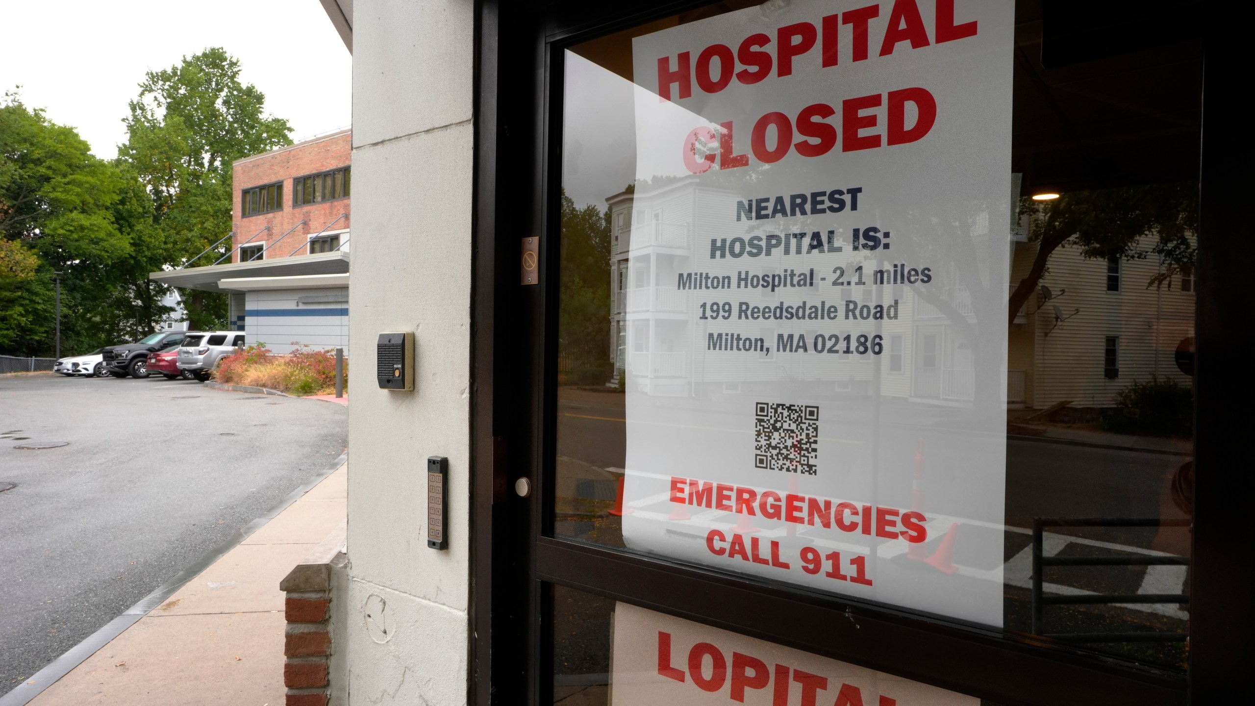 A closed sign is posted on a glass door at a entrance to a building on grounds of the closed Carney Hospital, Thursday, Sept. 19, 2024, in the Dorchester neighborhood of Boston. (AP Photo/Steven Senne)