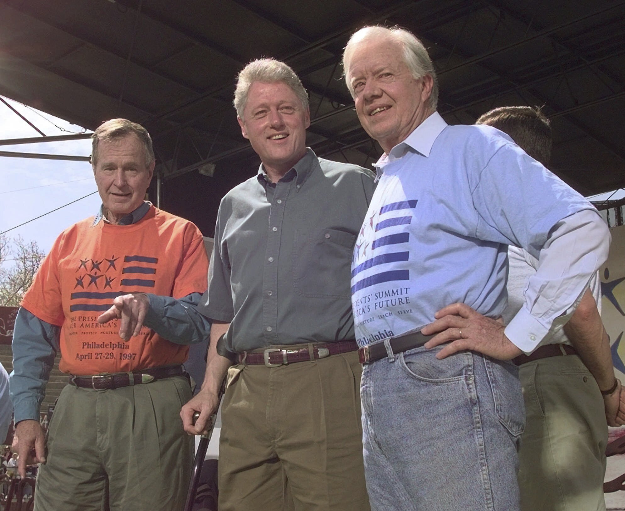 FILE - Former Presidents George Bush, left, and Jimmy Carter, right, stand with President Clinton during a kick-off rally for the President's volunteer summit at Marcus Foster Stadium in Philadelphia, PA., April 27, 1997. (AP Photo/Greg Gibson, File)