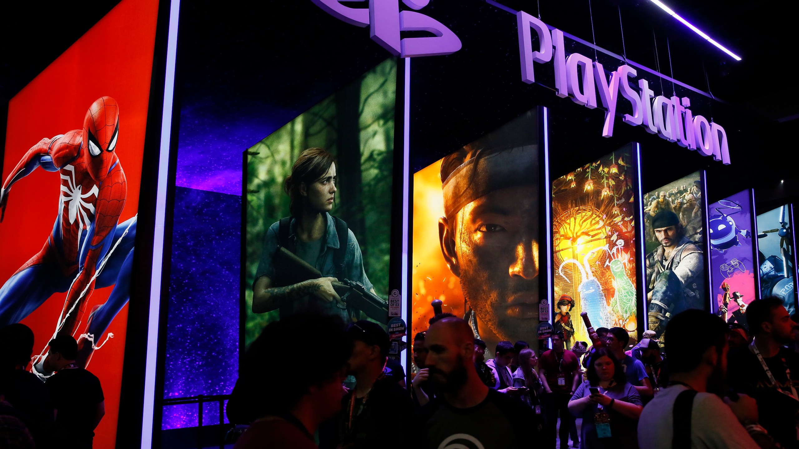 FILE - In this June 14, 2018, file people stand online next to the PlayStation booth at the 24th Electronic Entertainment Expo E3 at the Los Angeles Convention Center. (AP Photo/Damian Dovarganes, File)